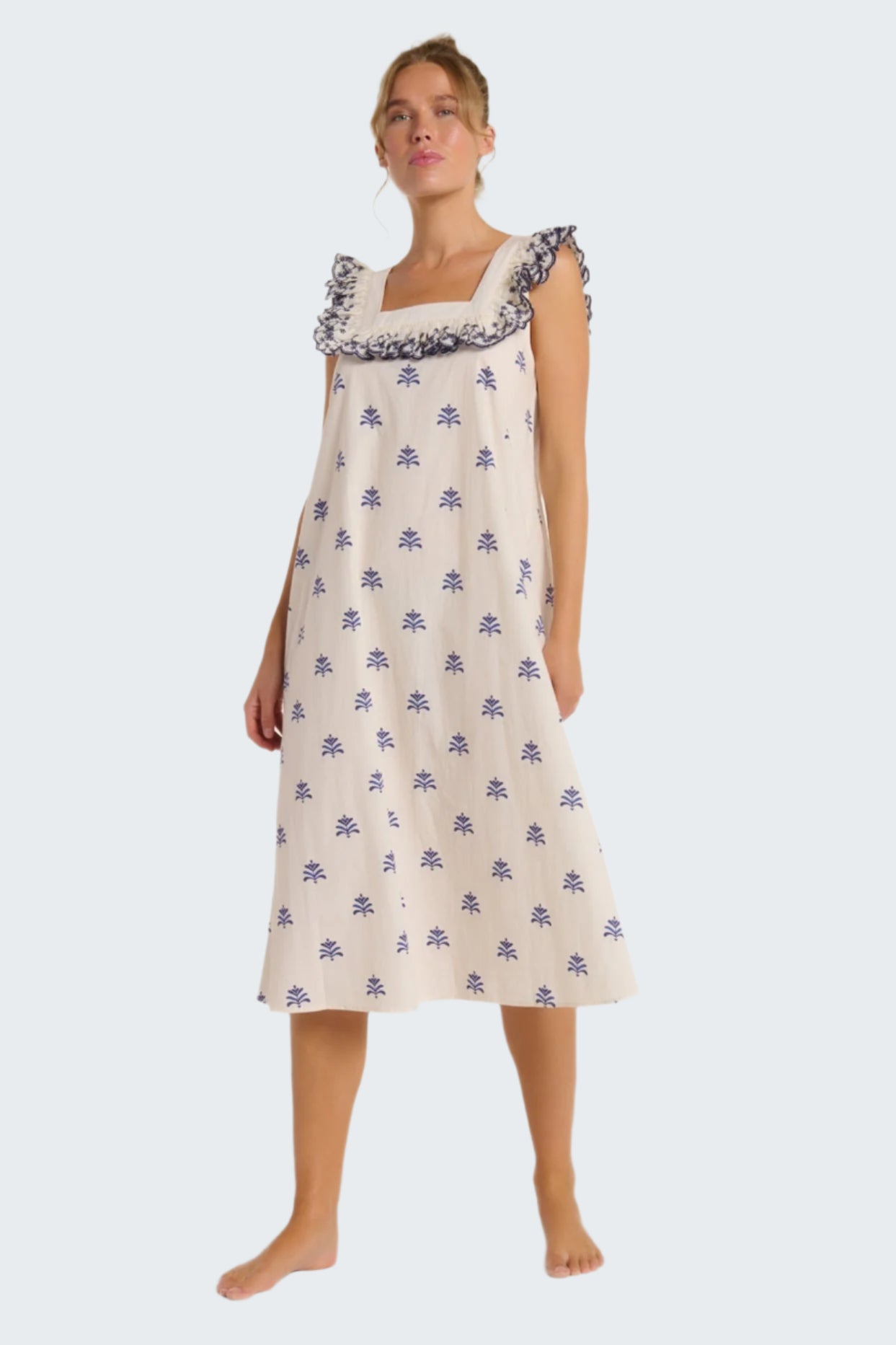 Woman wearing a floral nightgown on a white background