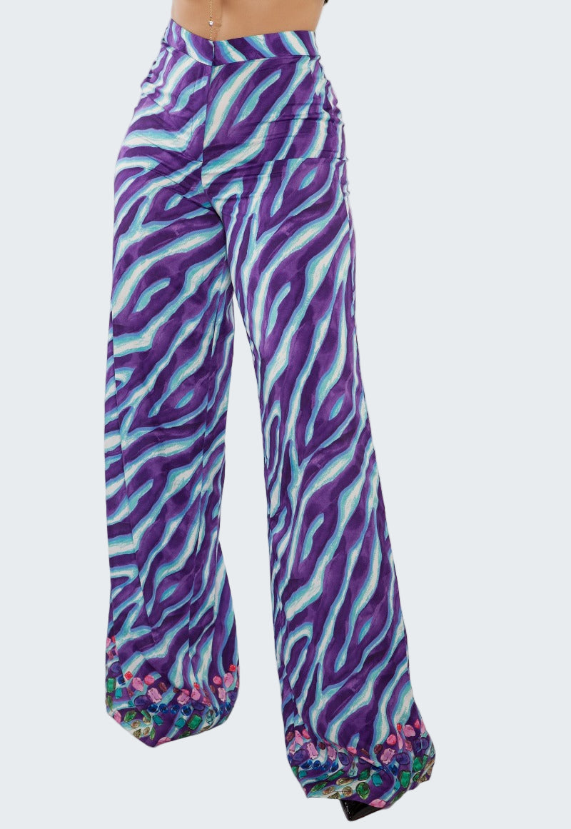 Purple and blue zebra print pants on a white background