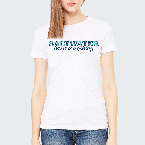 Person wearing a white t-shirt with 'Saltwater heals everything' text.