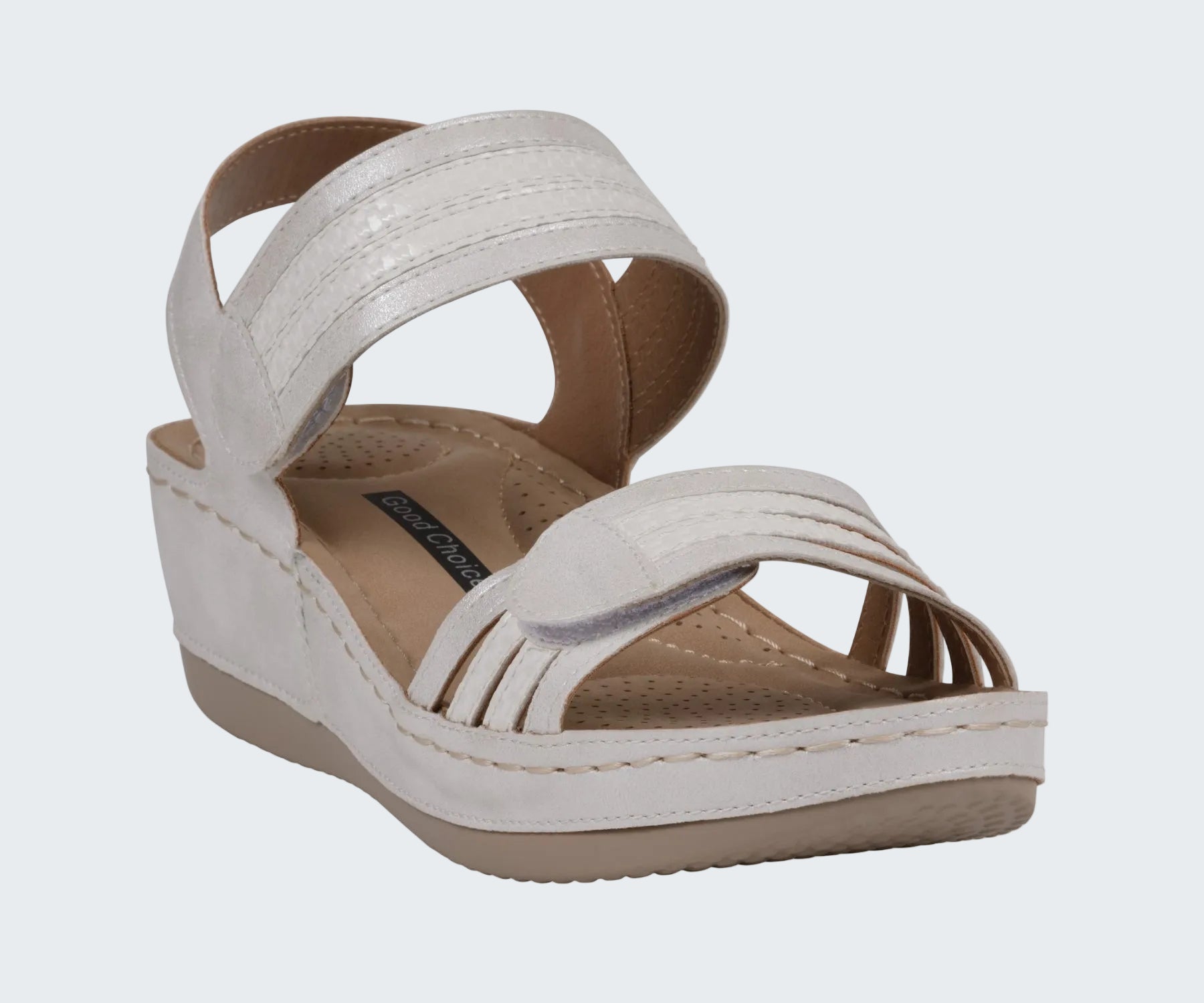 White wedge sandal with brown insole on a white background