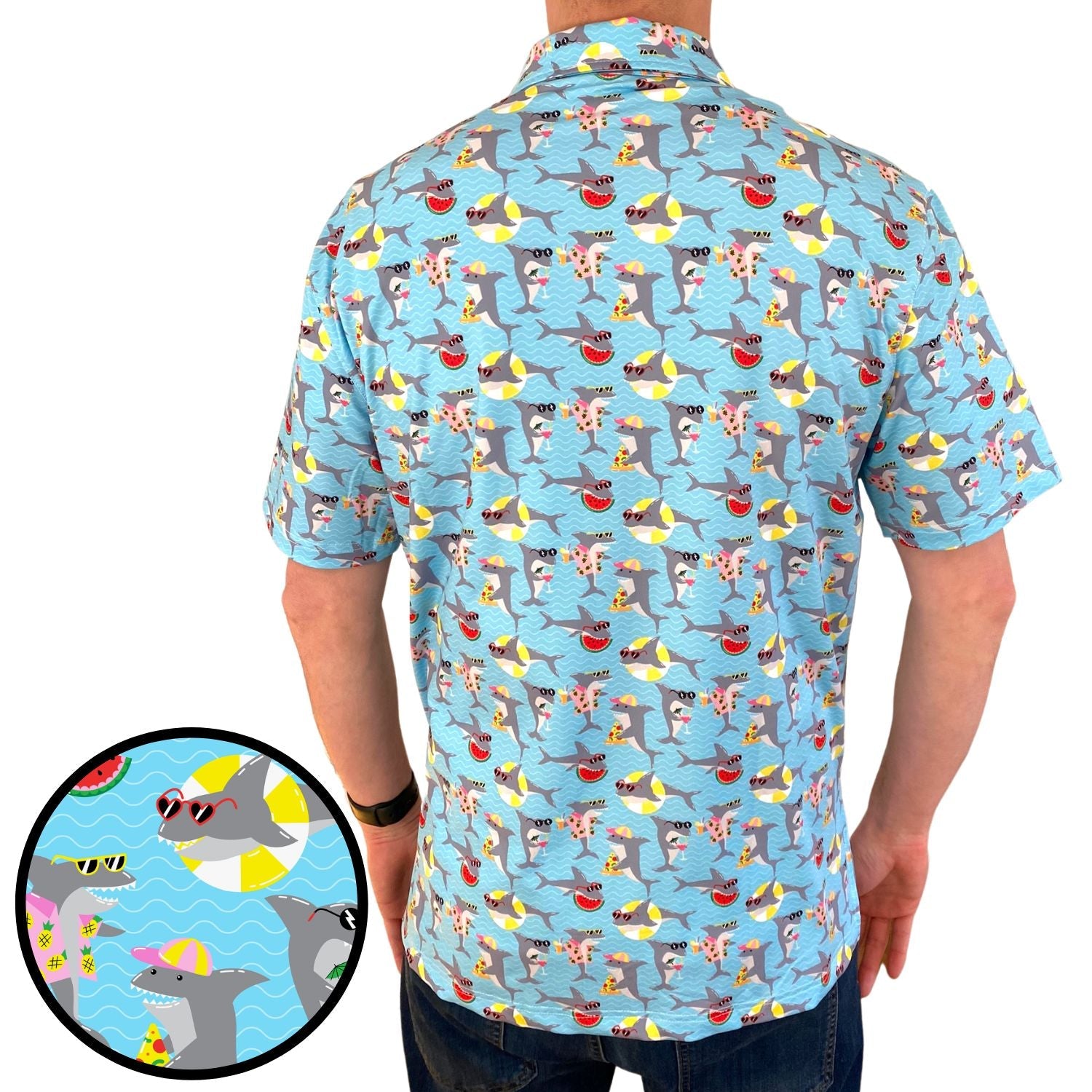 Person wearing a colorful shark-themed shirt with a close-up of the pattern on a blue background.