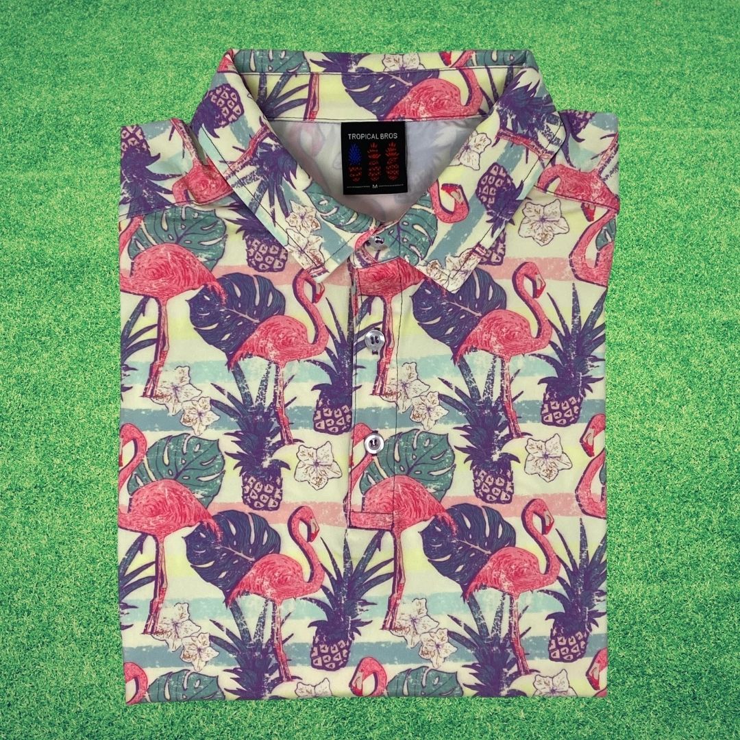 Floral and flamingo patterned shirt on a green background