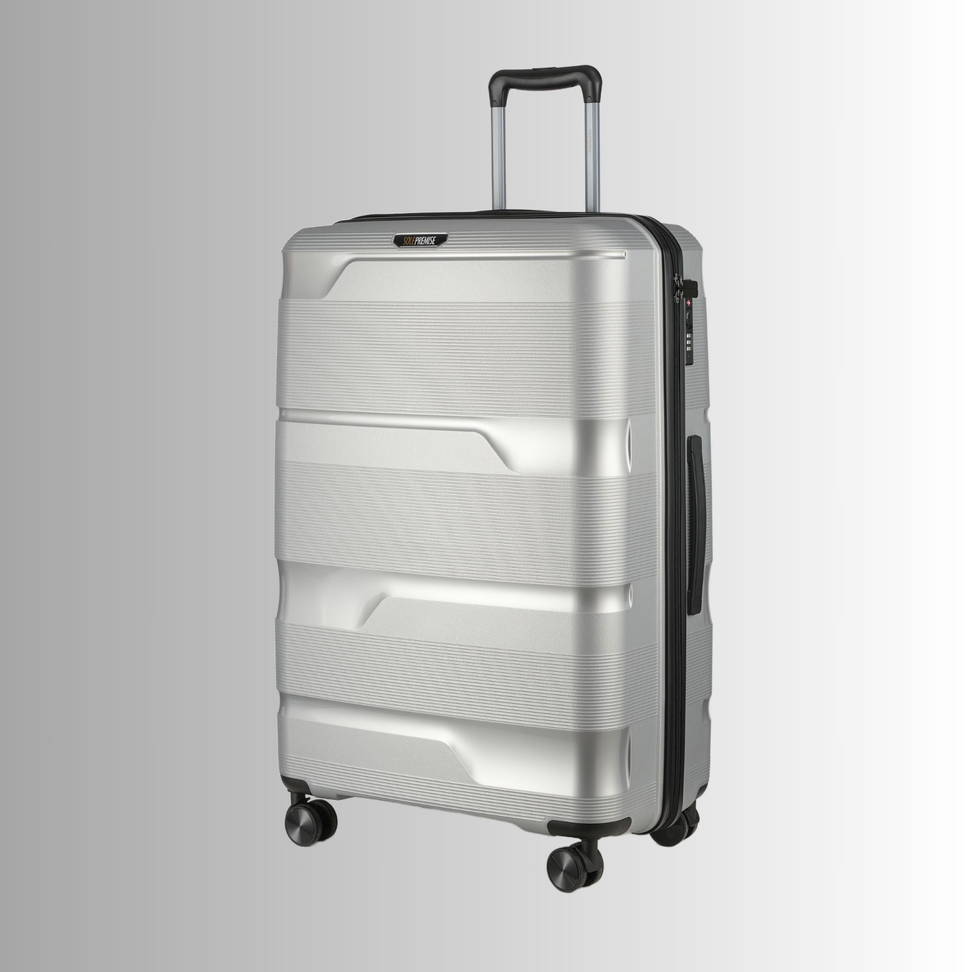 Silver suitcase with black handle and wheels on a light gray background