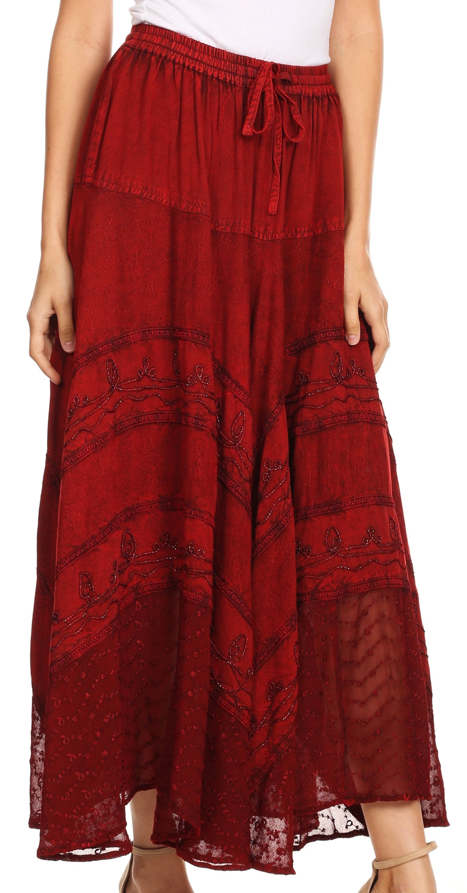 Red patterned skirt worn by a person on a white background
