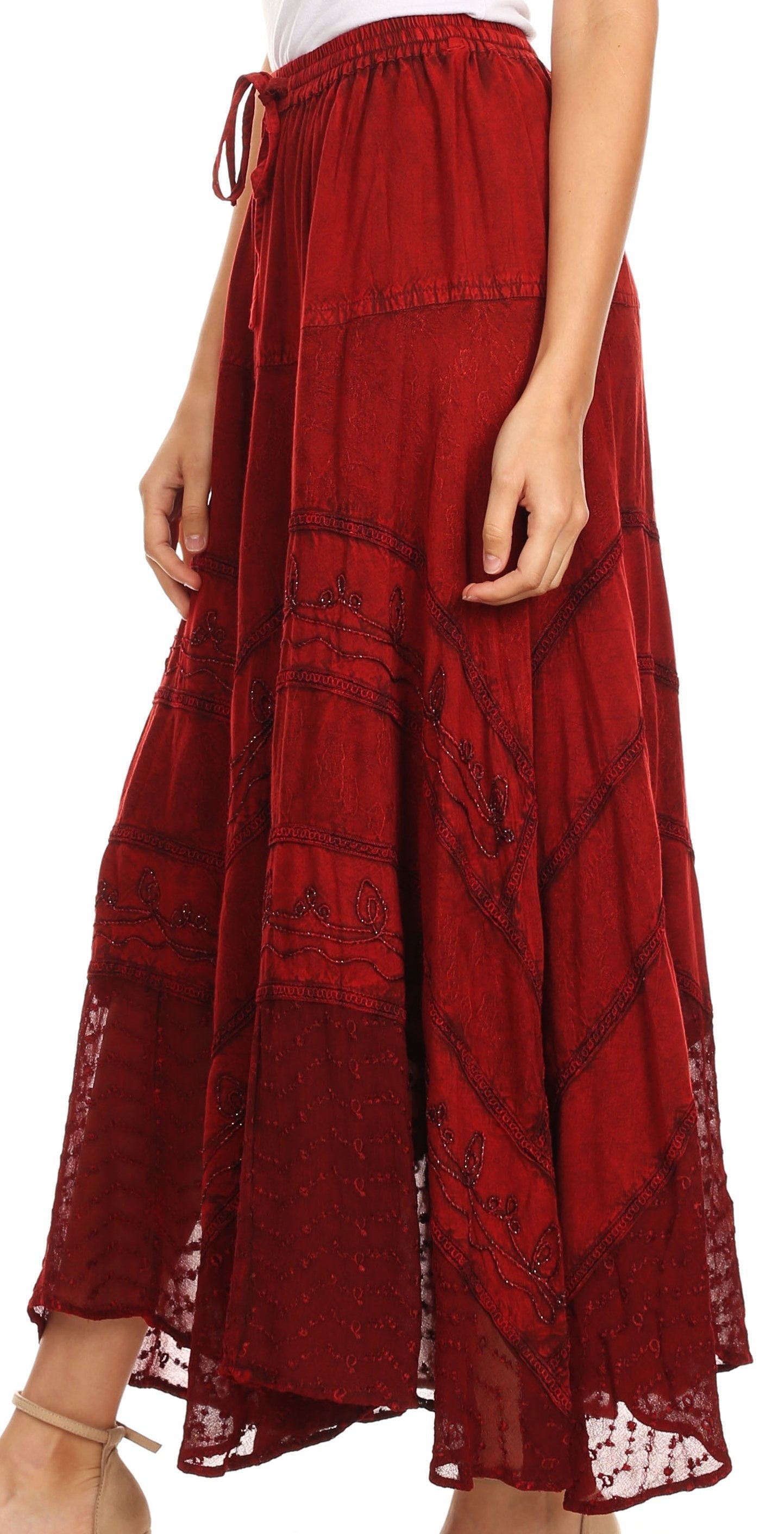 Red patterned skirt worn by a person on a white background
