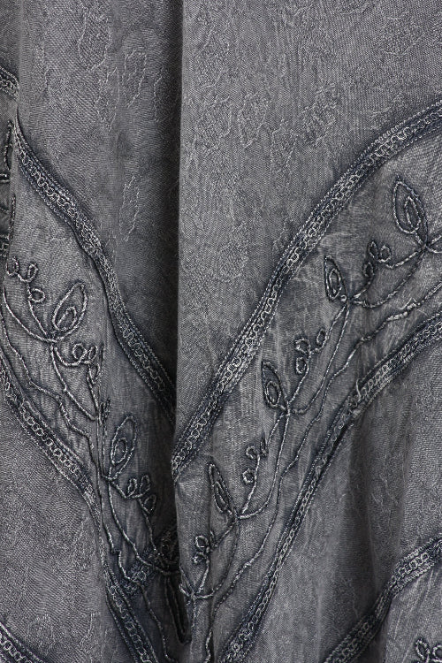 Close-up of a textured fabric with embroidered details