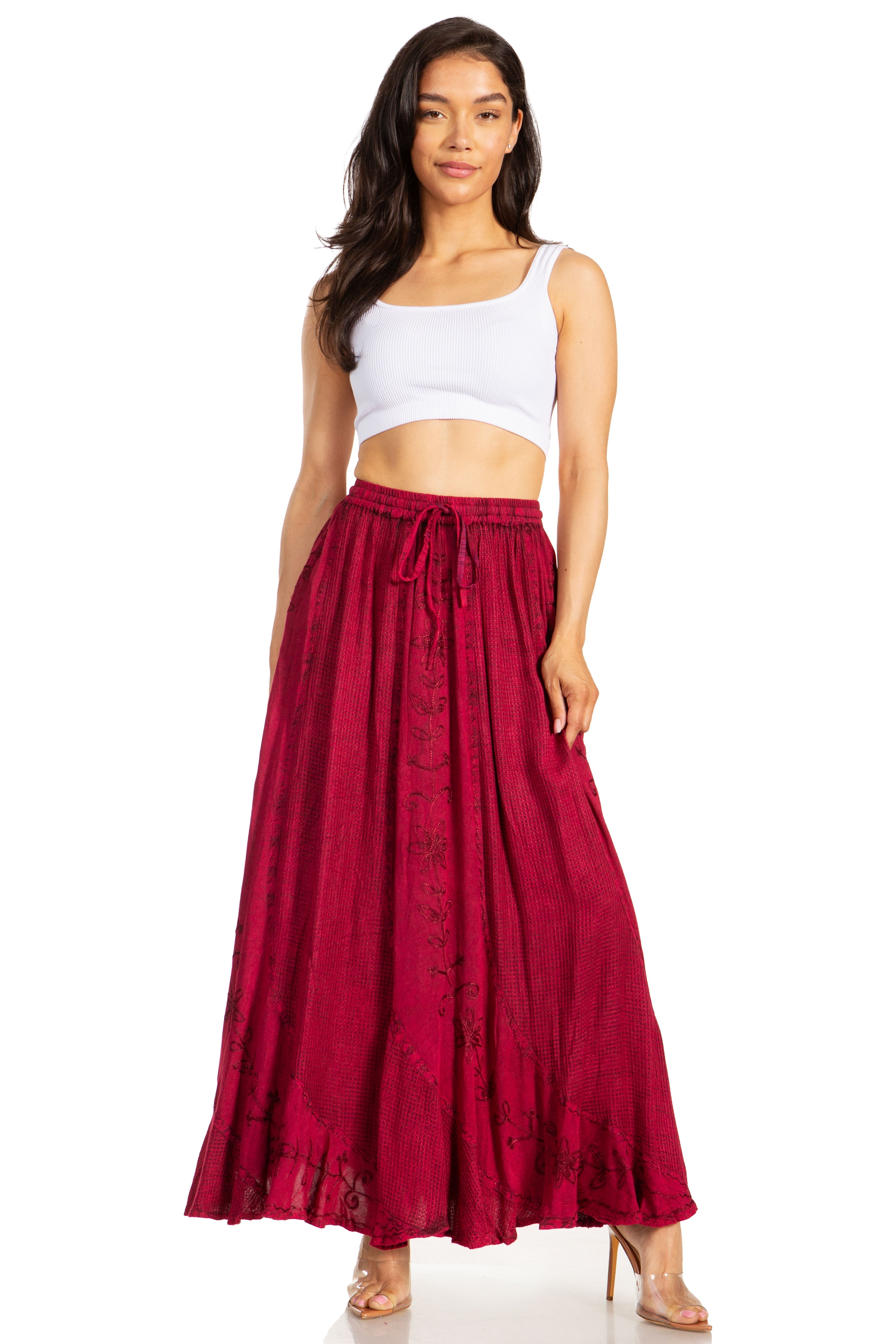 Woman wearing a white crop top and red skirt on a white background