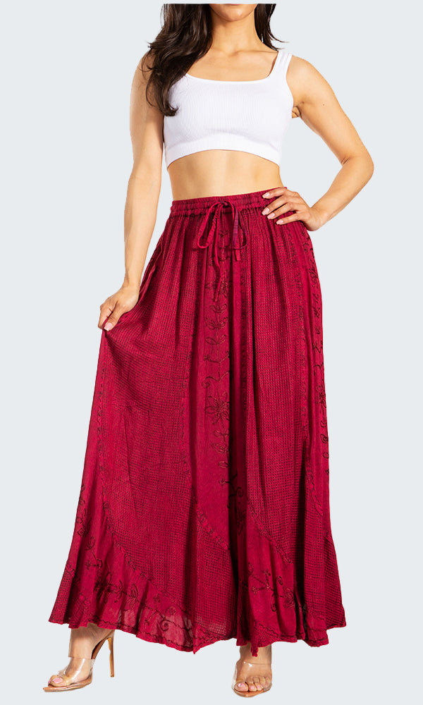 Woman wearing a white crop top and red skirt on a white background