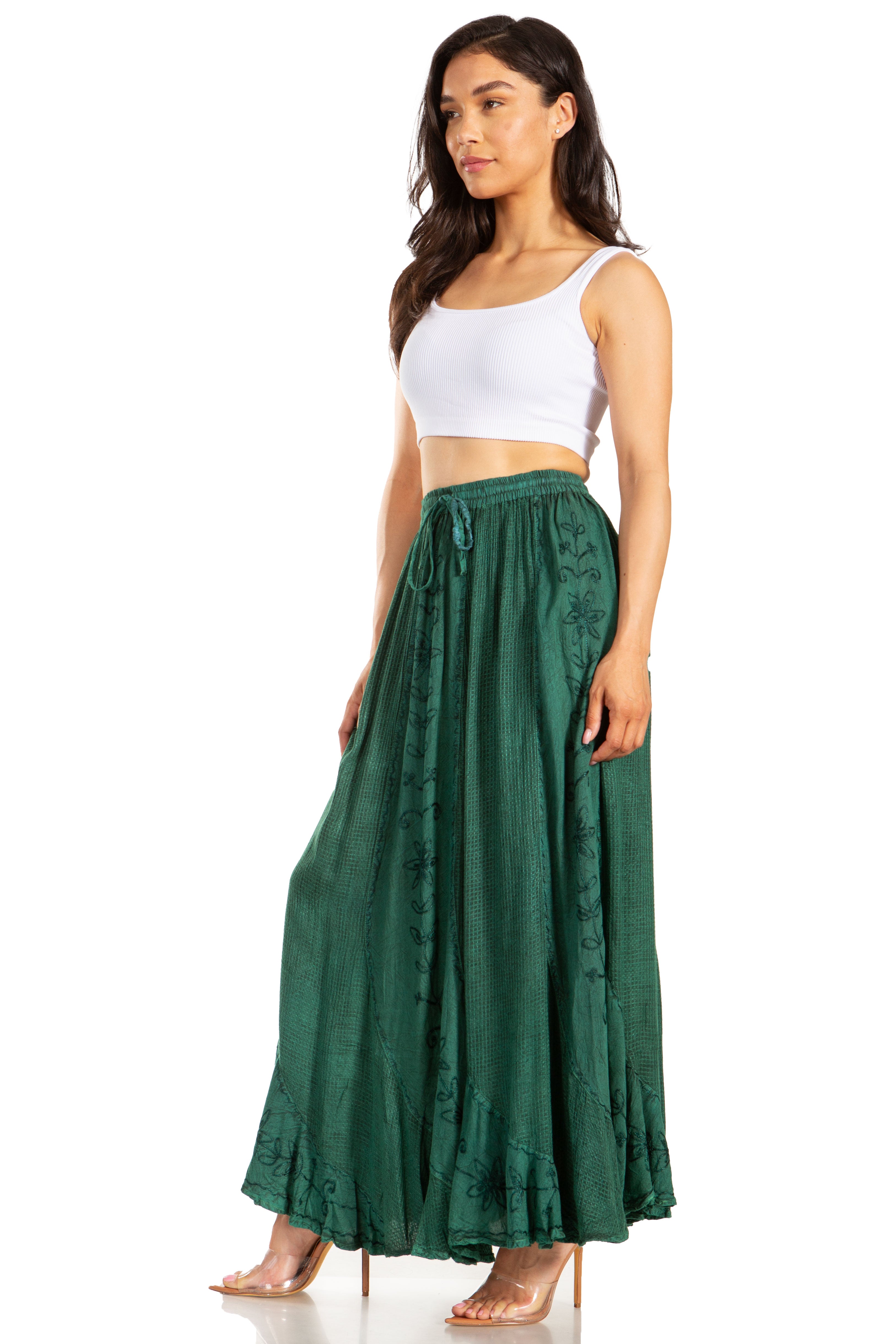 Woman wearing a white top and green skirt on a white background