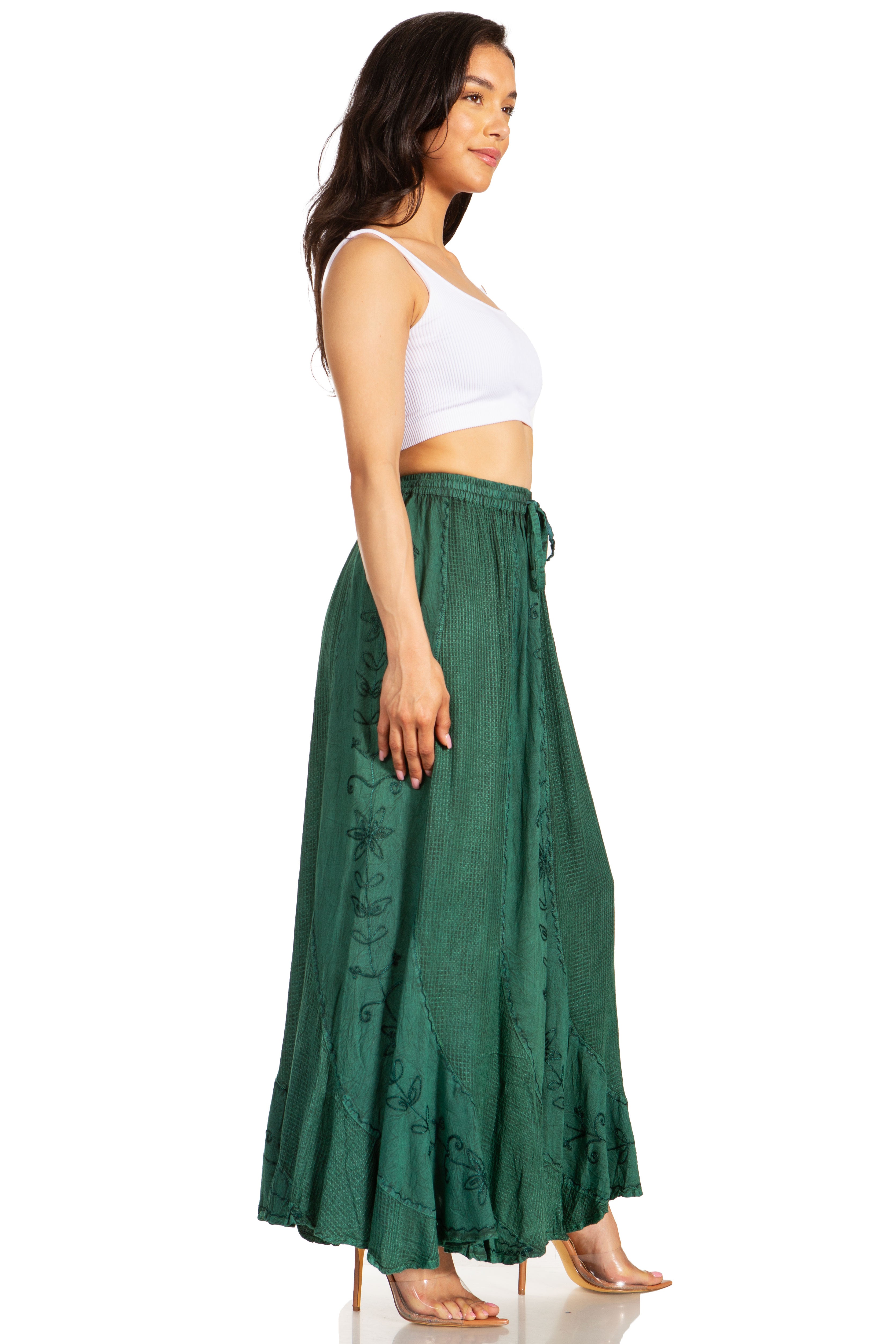 Woman wearing a white top and green skirt on a white background