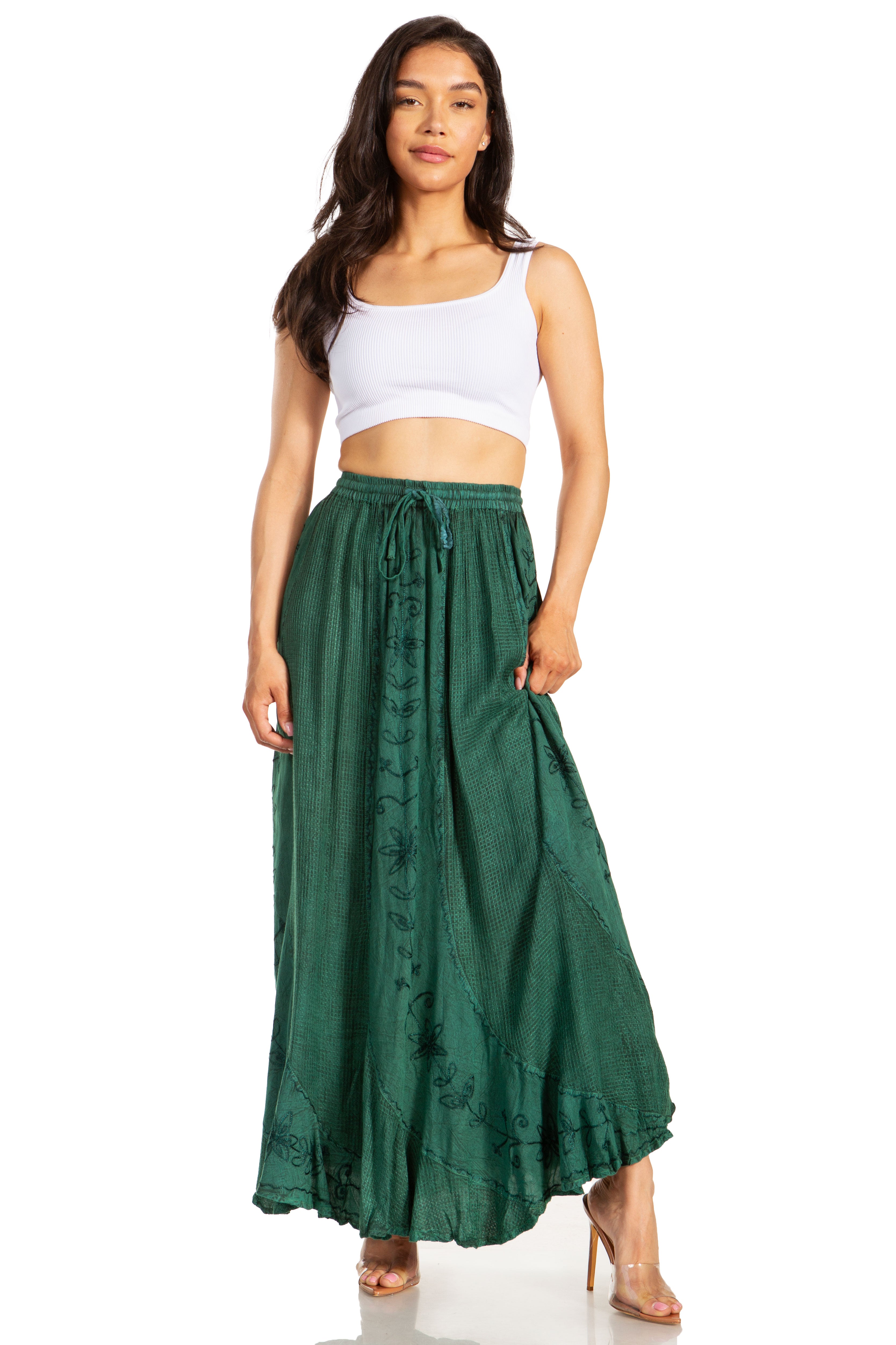 Woman wearing a white top and green skirt on a white background