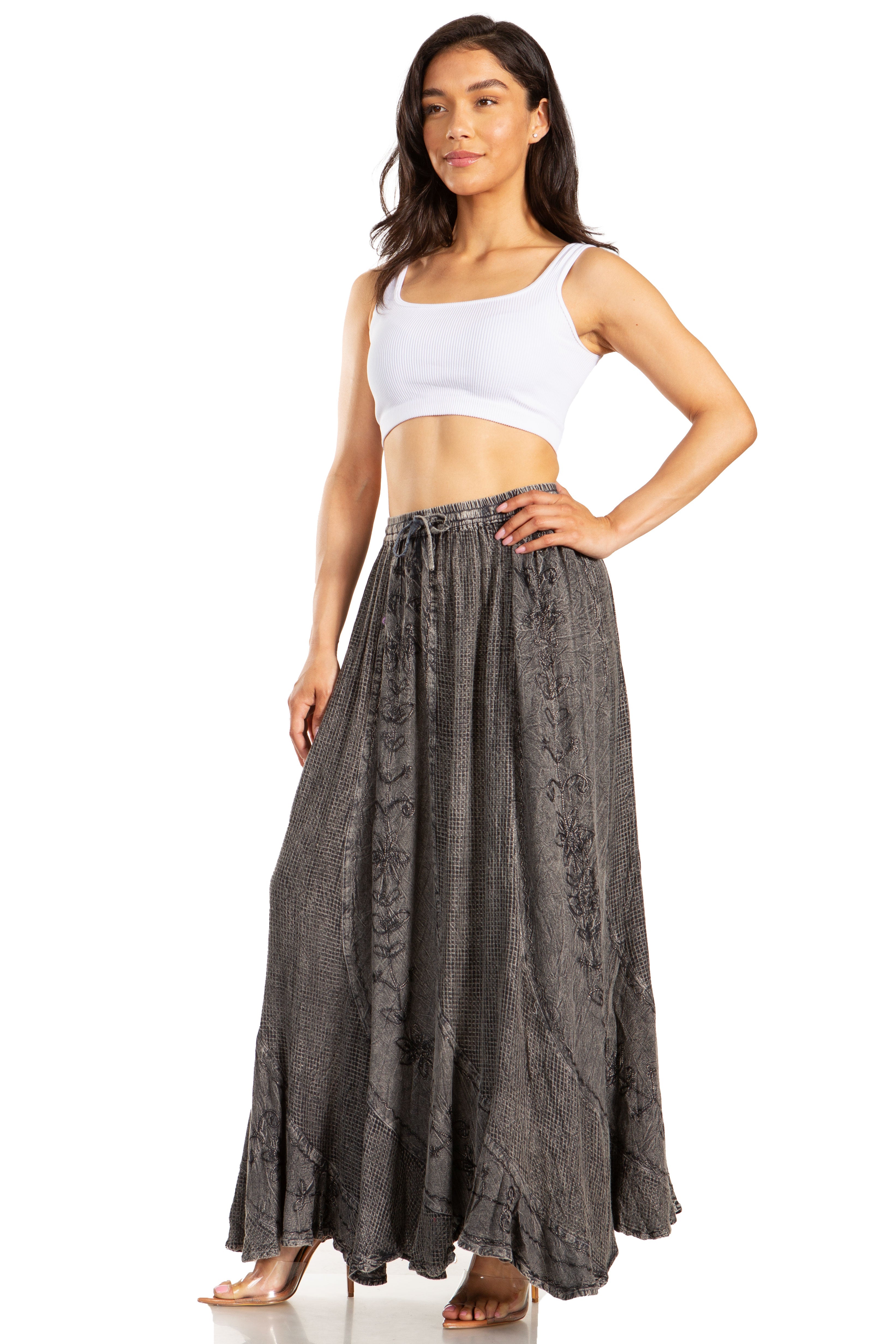 Woman wearing a white top and long gray skirt on a white background
