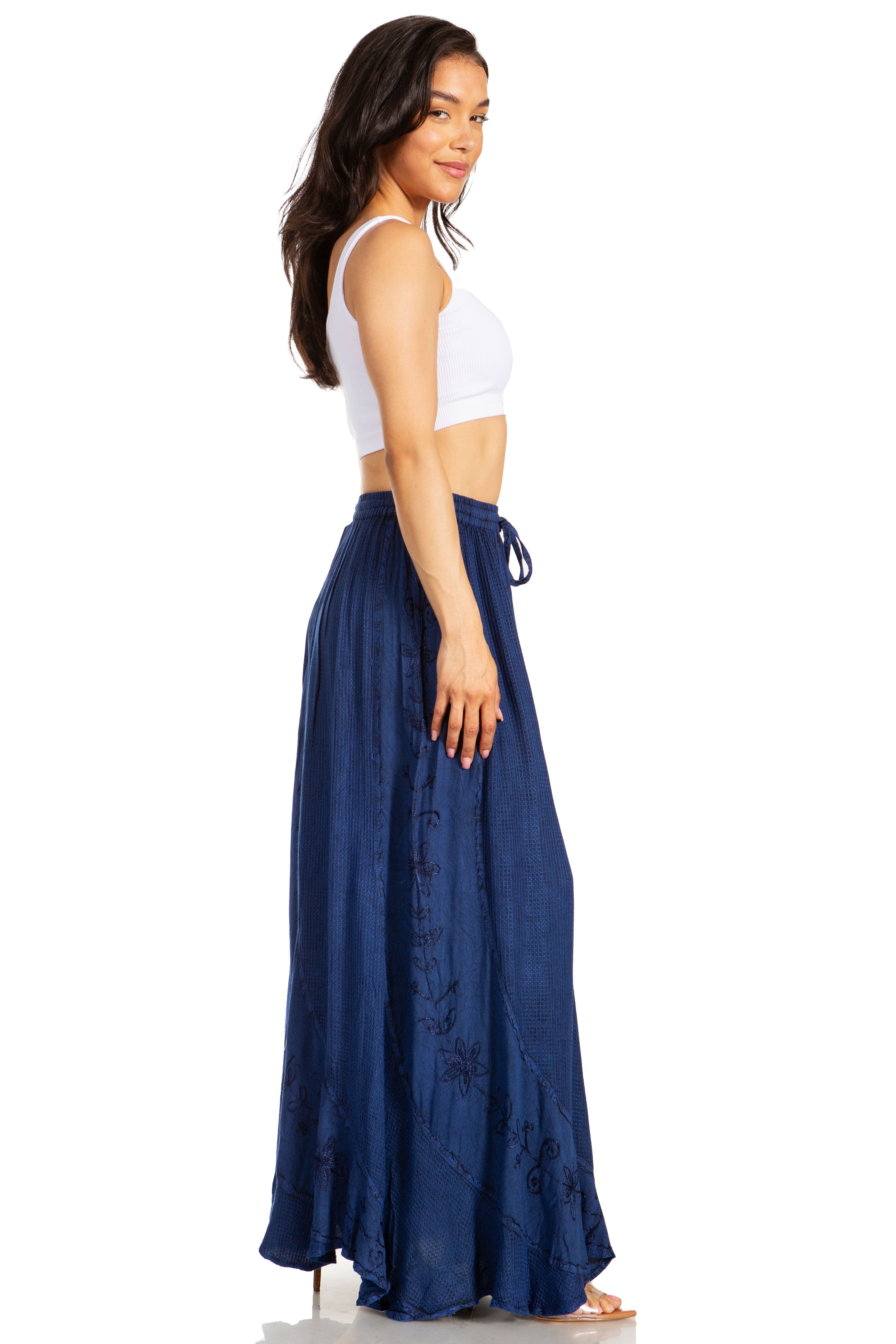 Woman wearing a white top and blue skirt on a white background