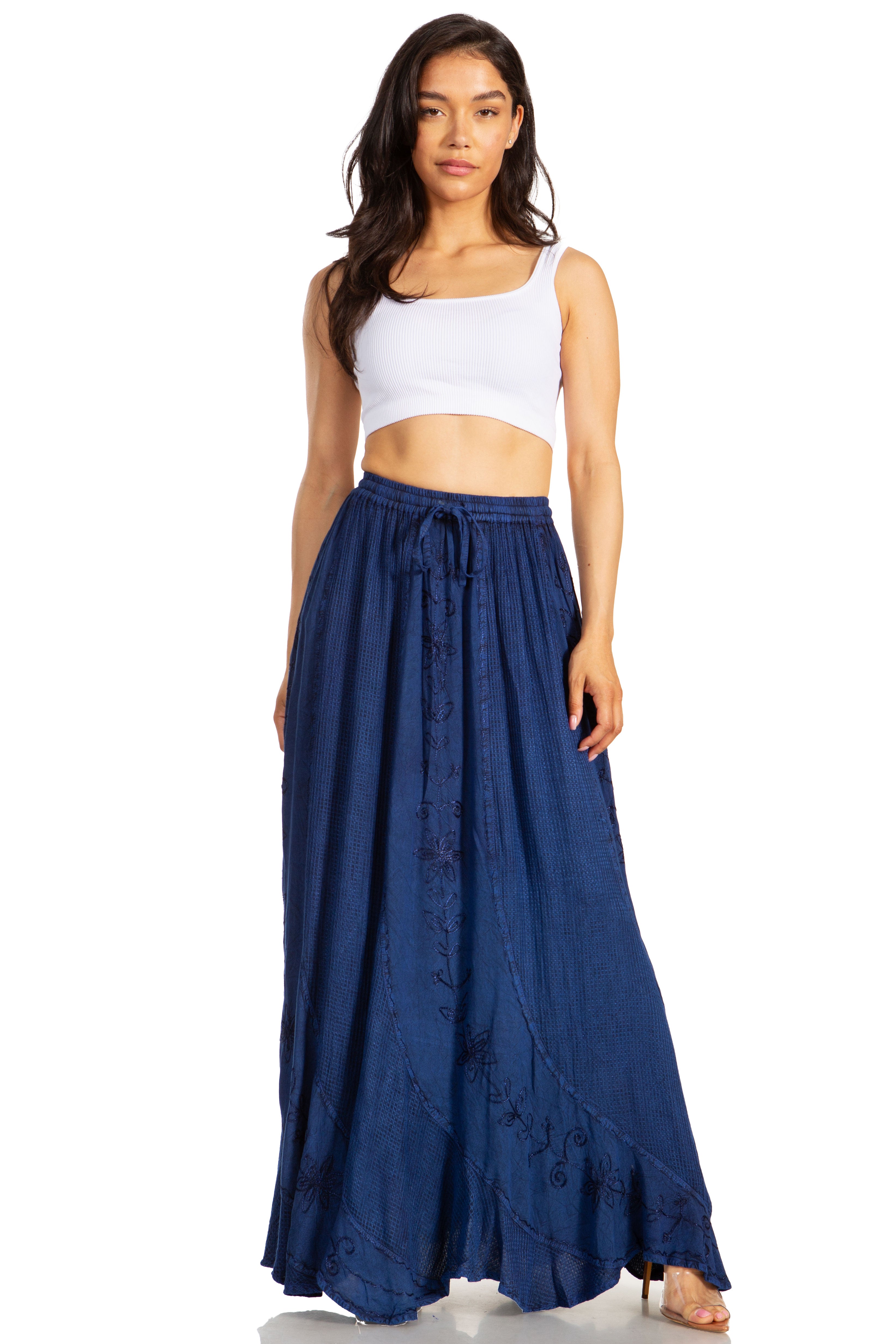 Woman wearing a white crop top and blue denim skirt on a white background
