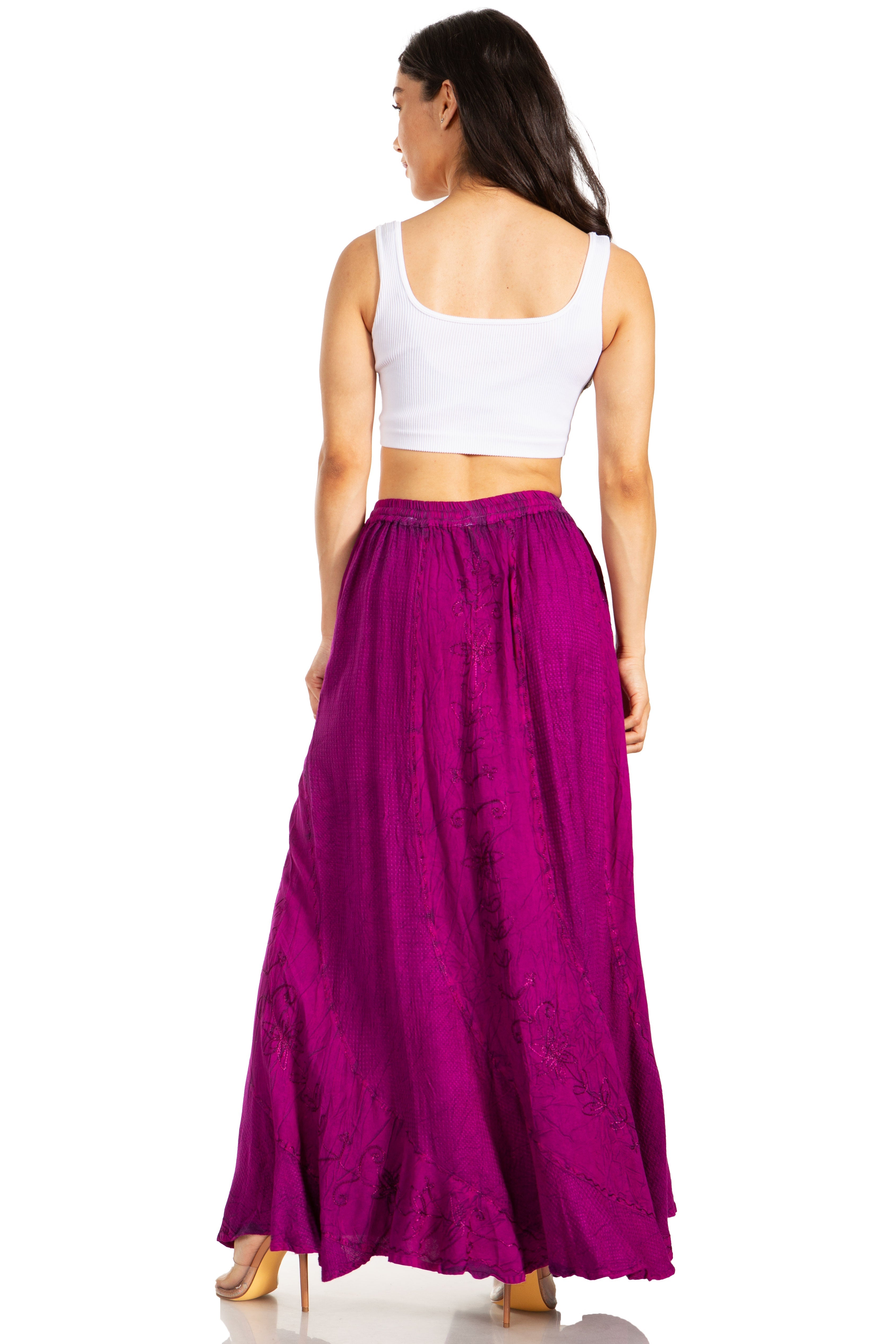 Woman wearing a white top and purple skirt on a white background