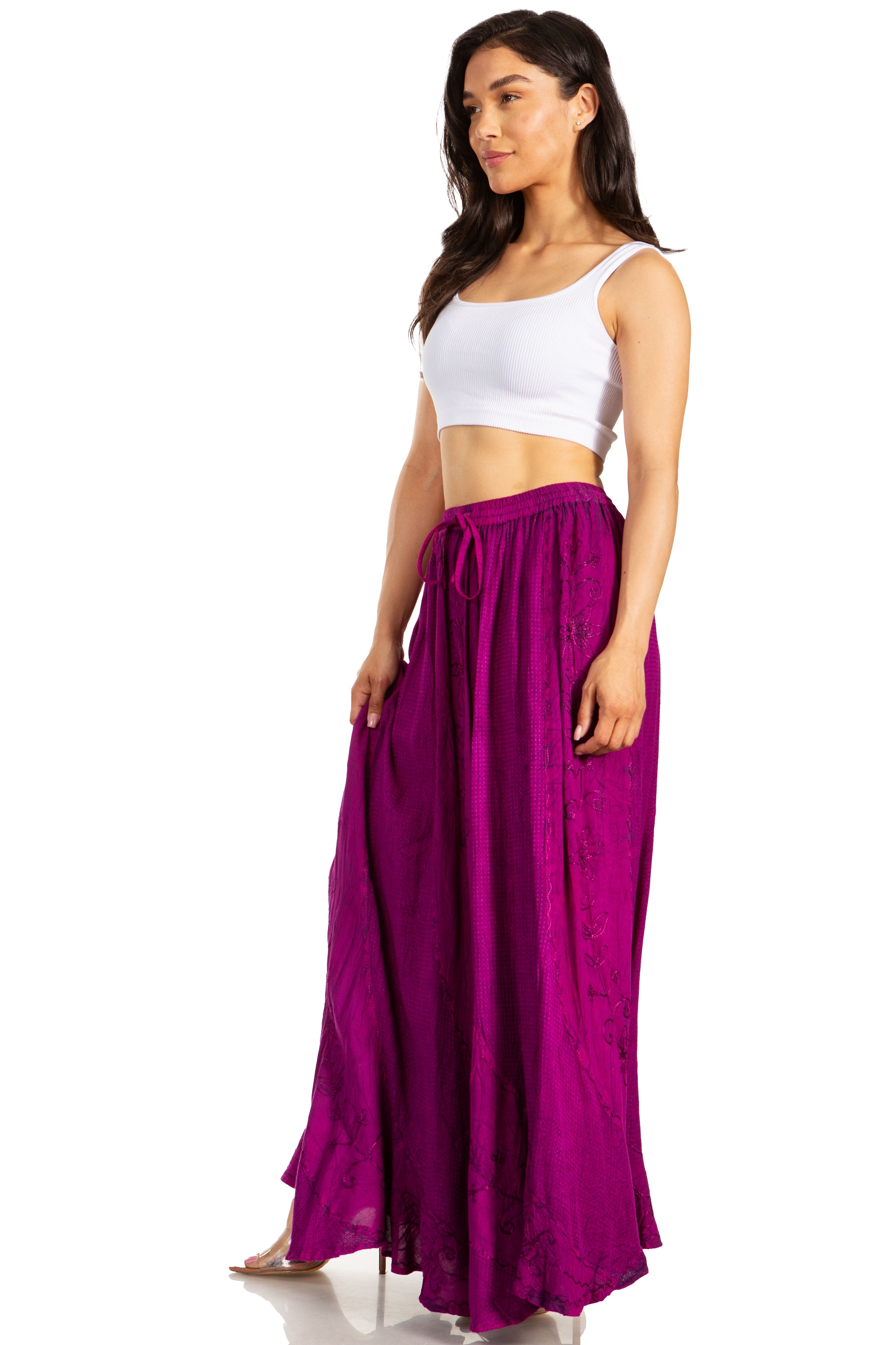 Woman wearing a white top and purple skirt on a white background