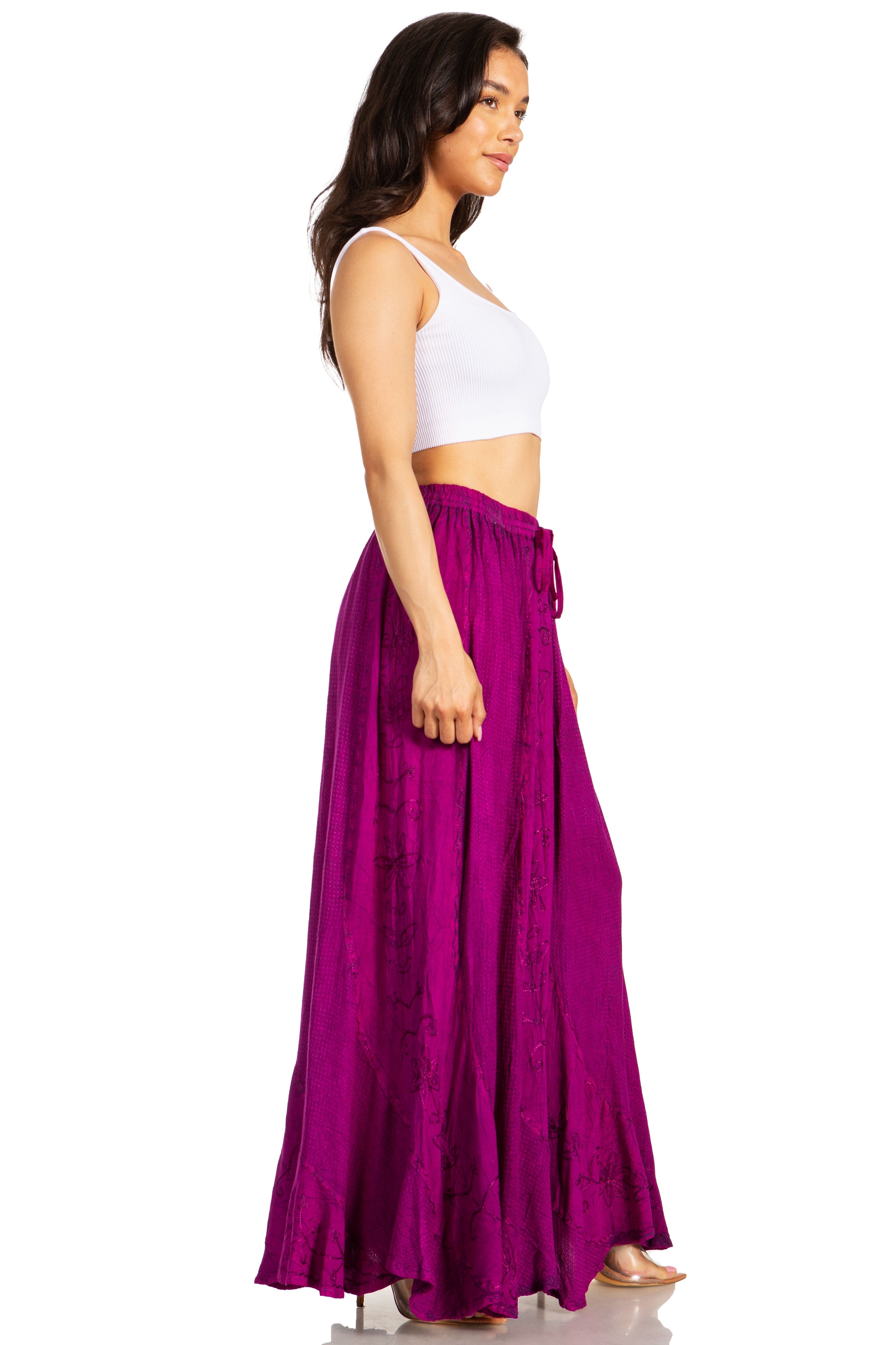 Woman wearing a white top and purple skirt on a white background