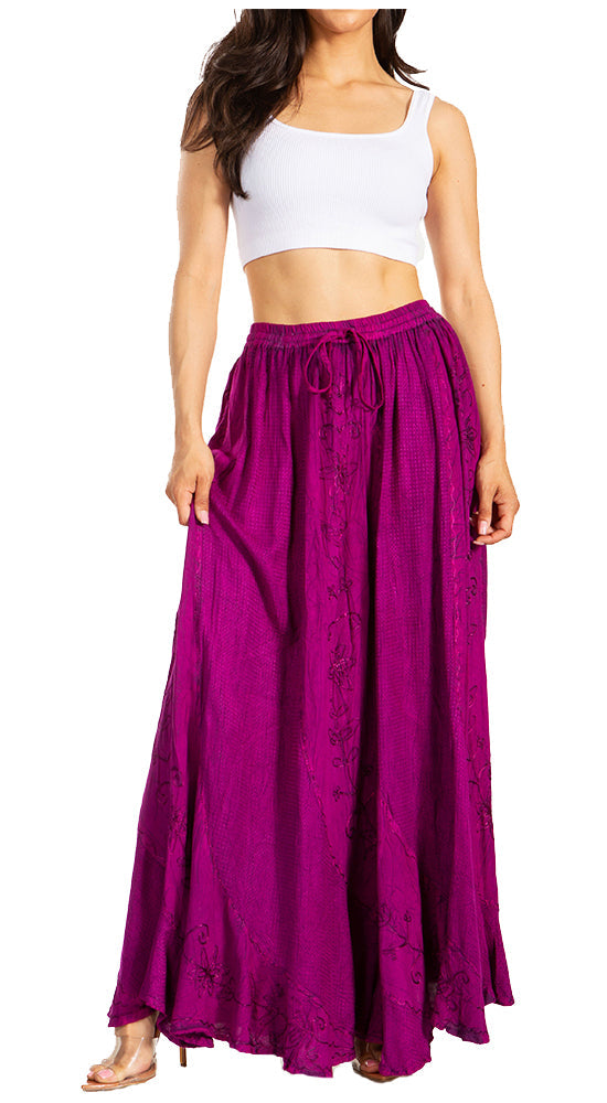 Woman wearing a long purple skirt with a white top on a white background