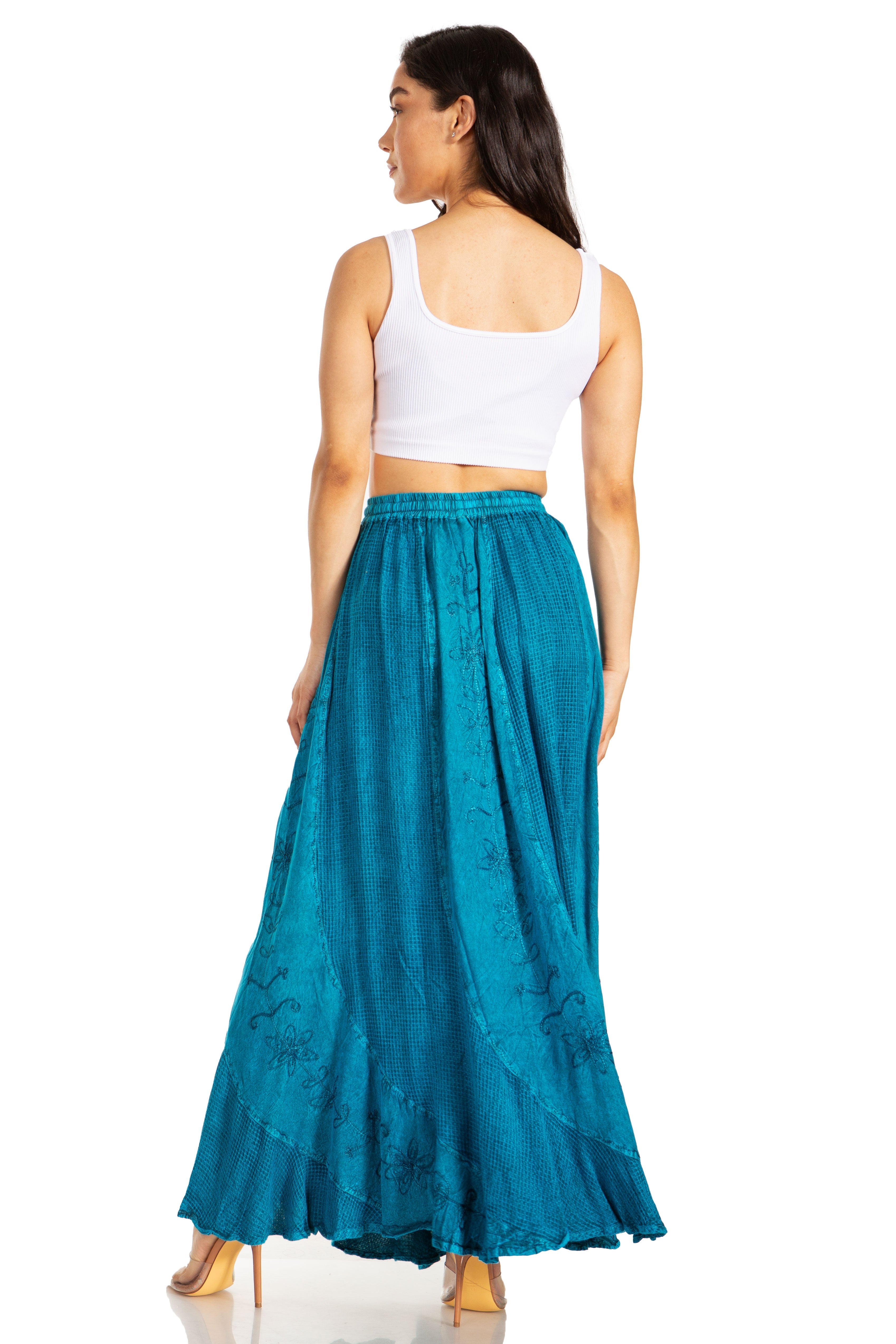 Woman wearing a white top and teal skirt on a white background