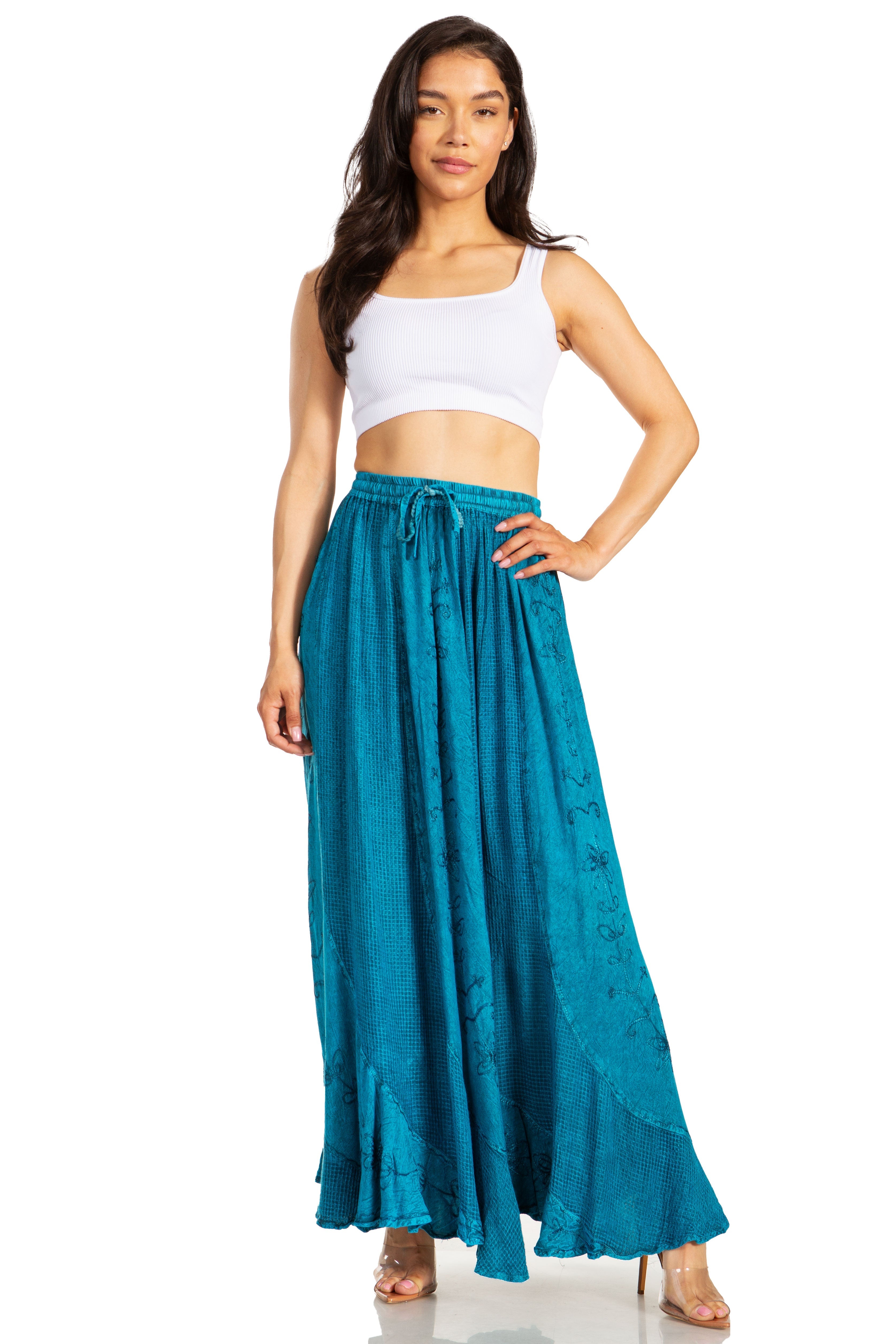 Woman wearing a white top and teal skirt on a white background