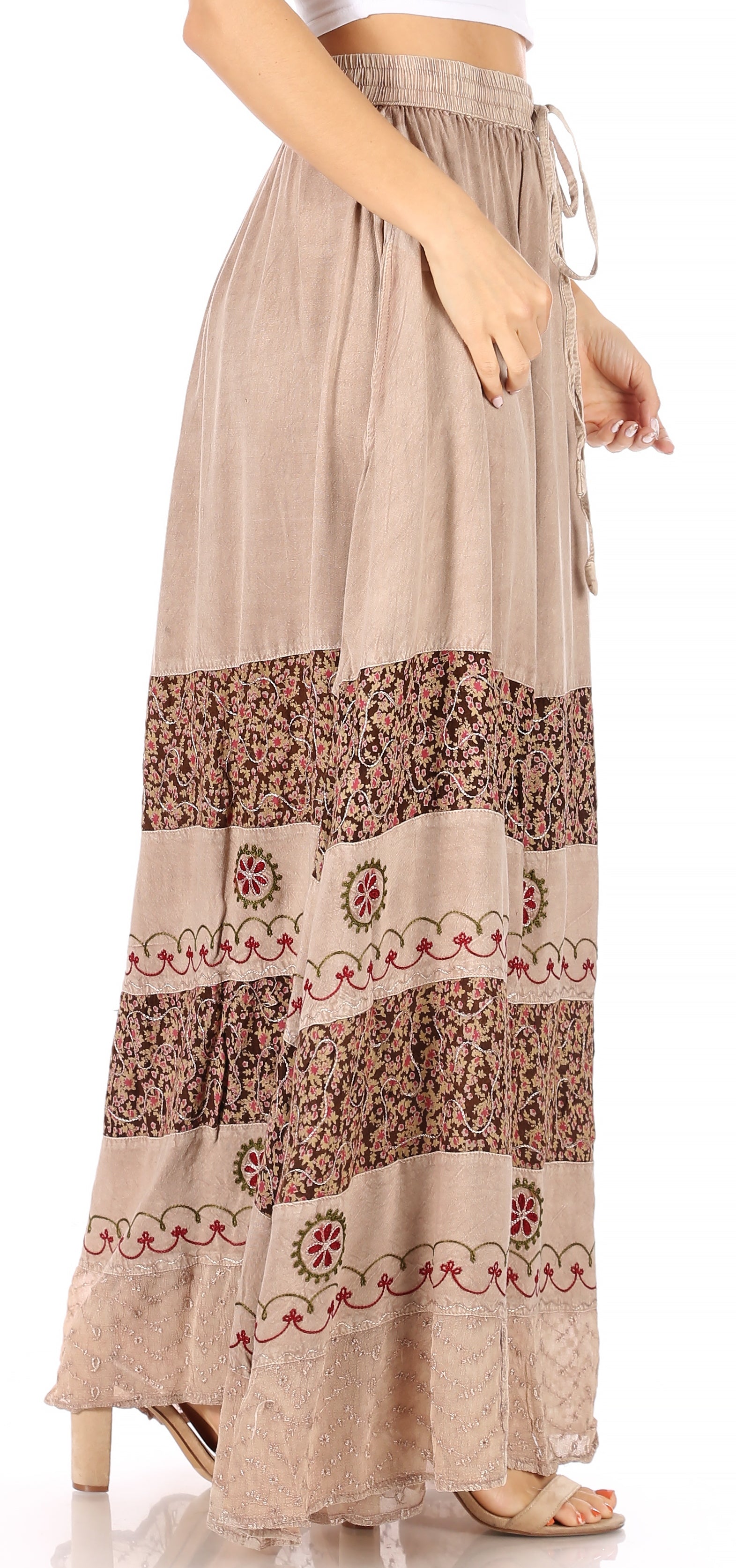 Beige long skirt with floral patterns on a white background