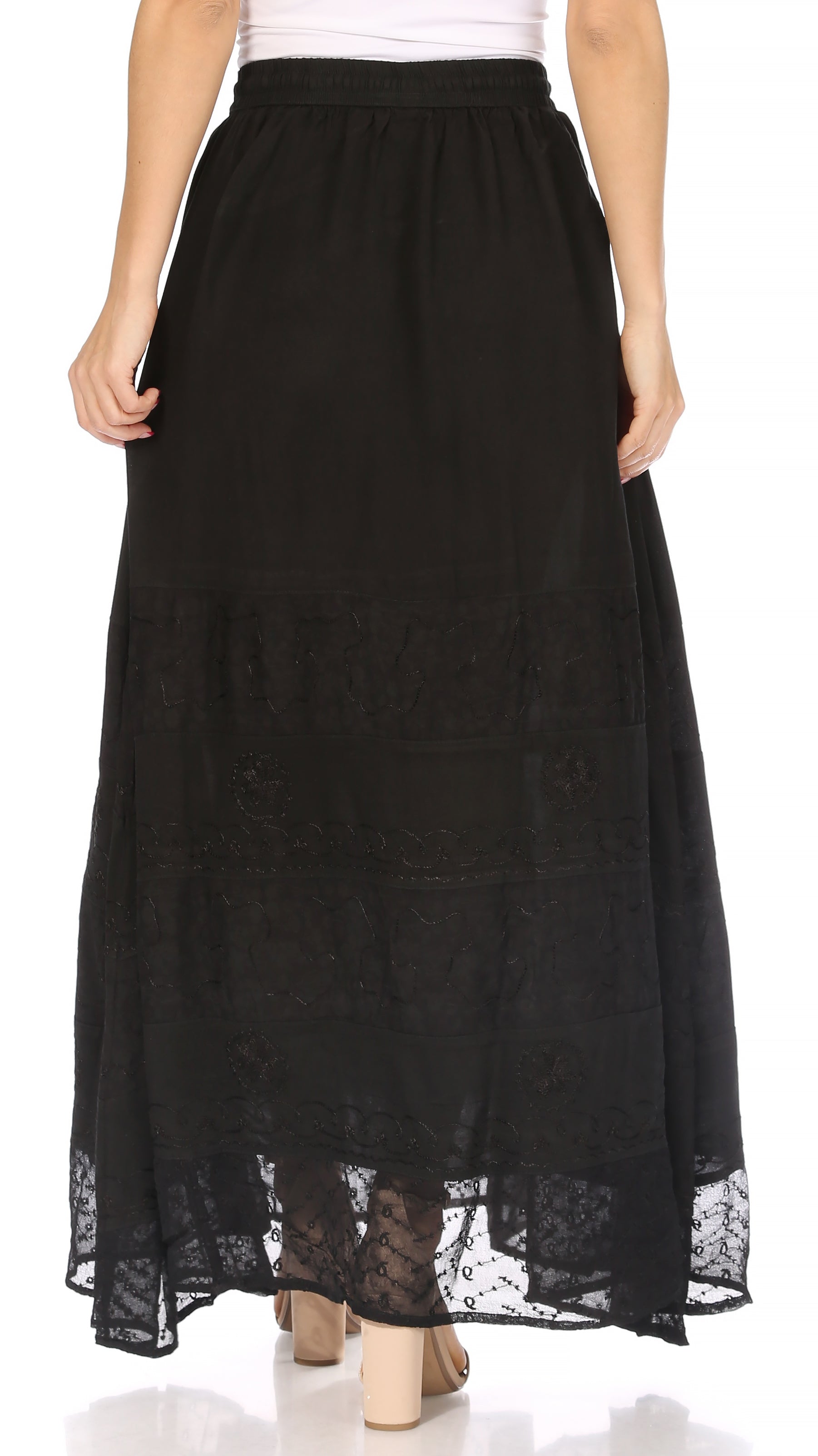 Black lace-trimmed skirt worn by a person on a white background