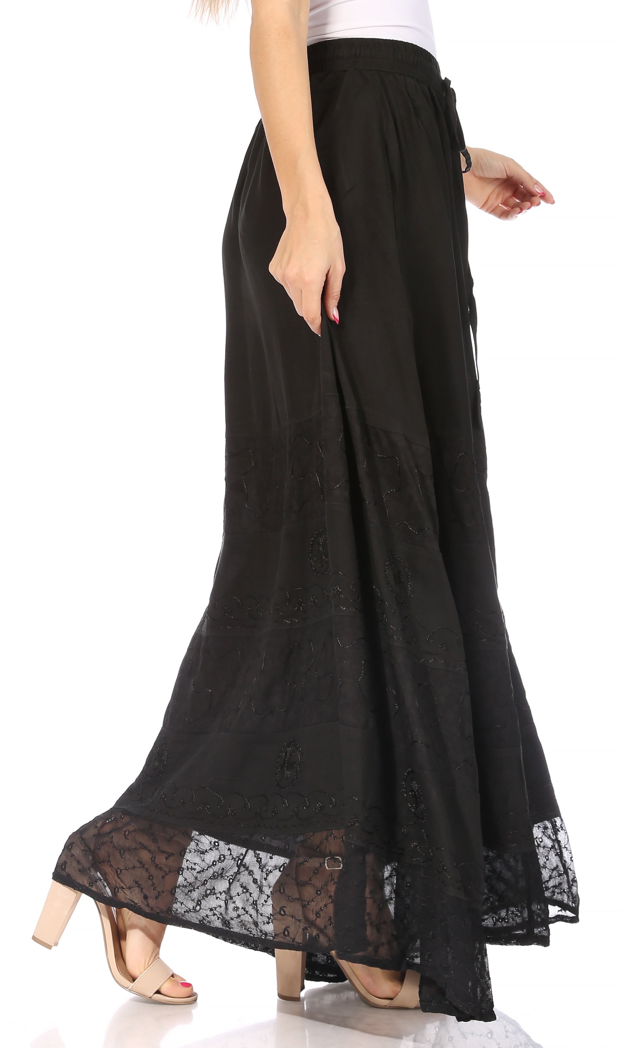 Black lace-trimmed skirt worn by a model on a white background