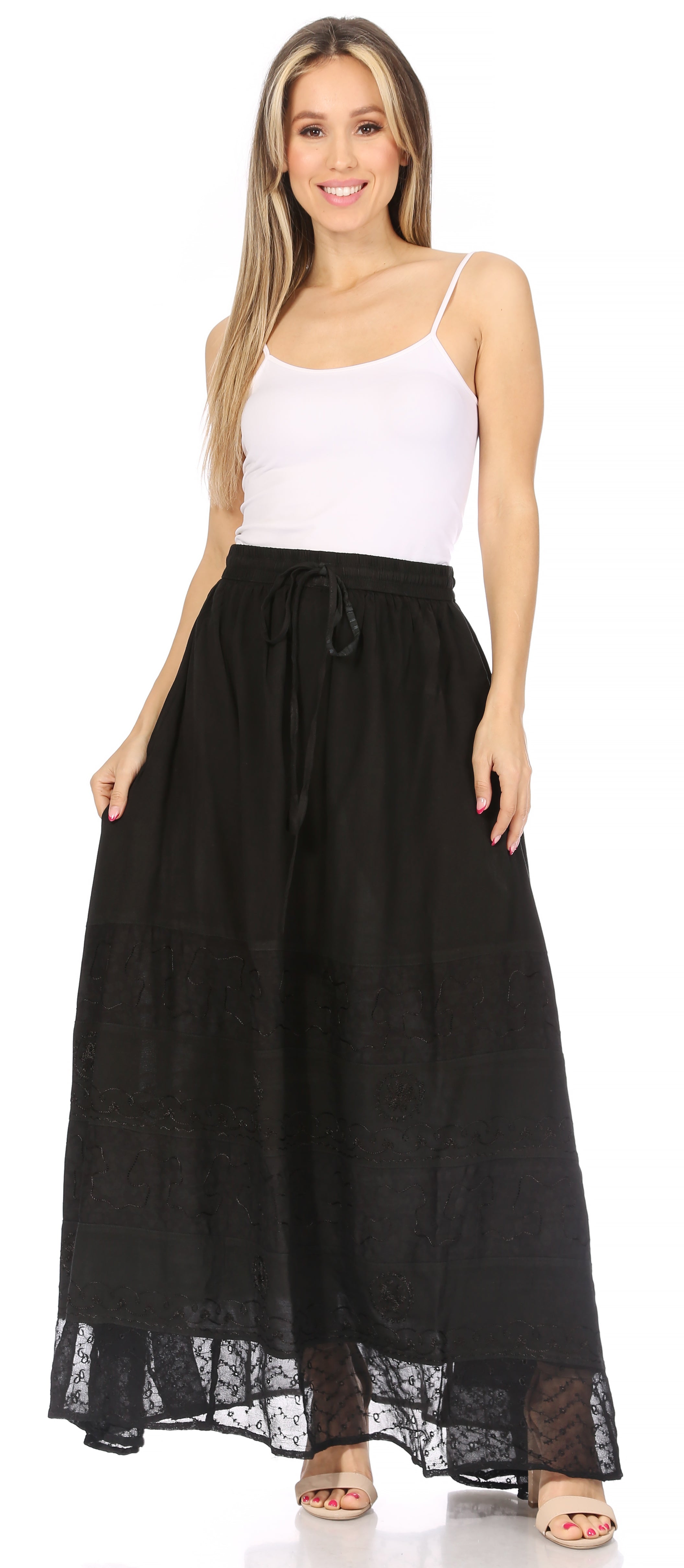 Woman wearing a black skirt with lace trim and a white top on a white background