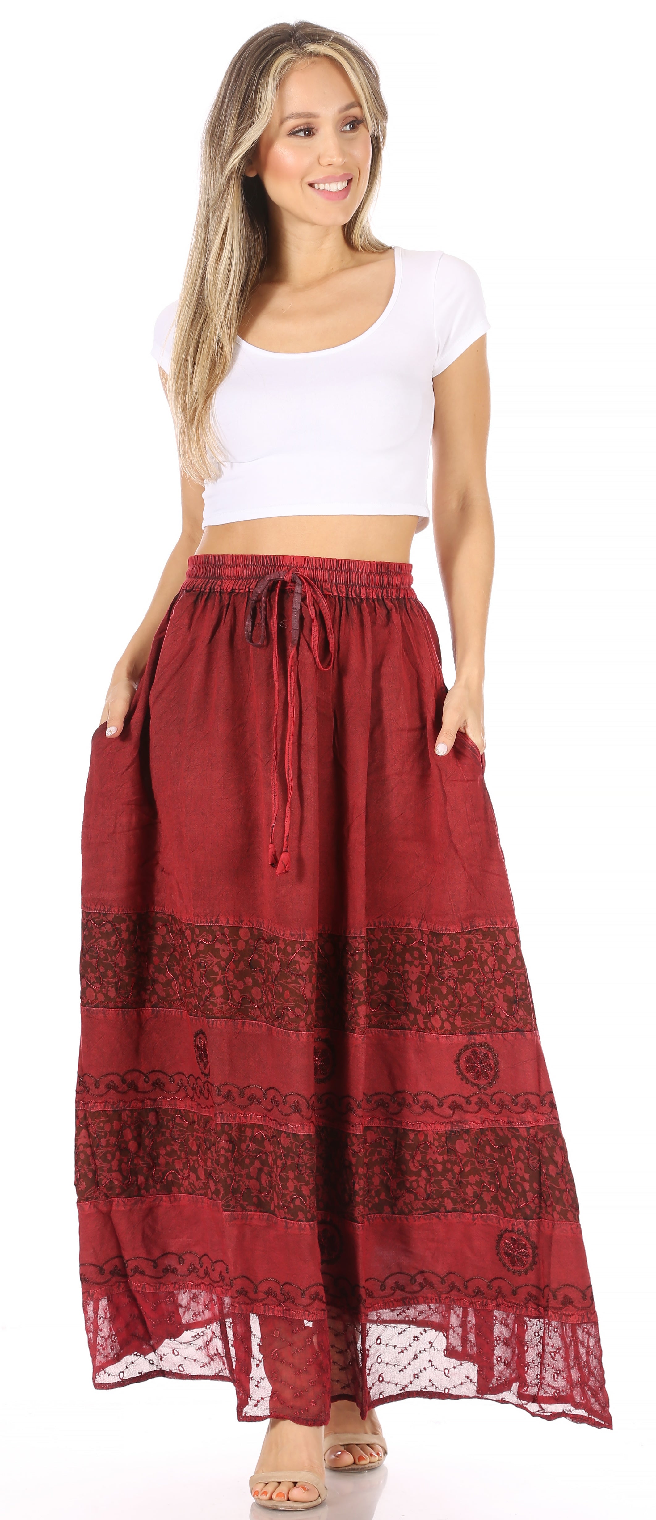 Woman wearing a long red skirt with patterns on a white background