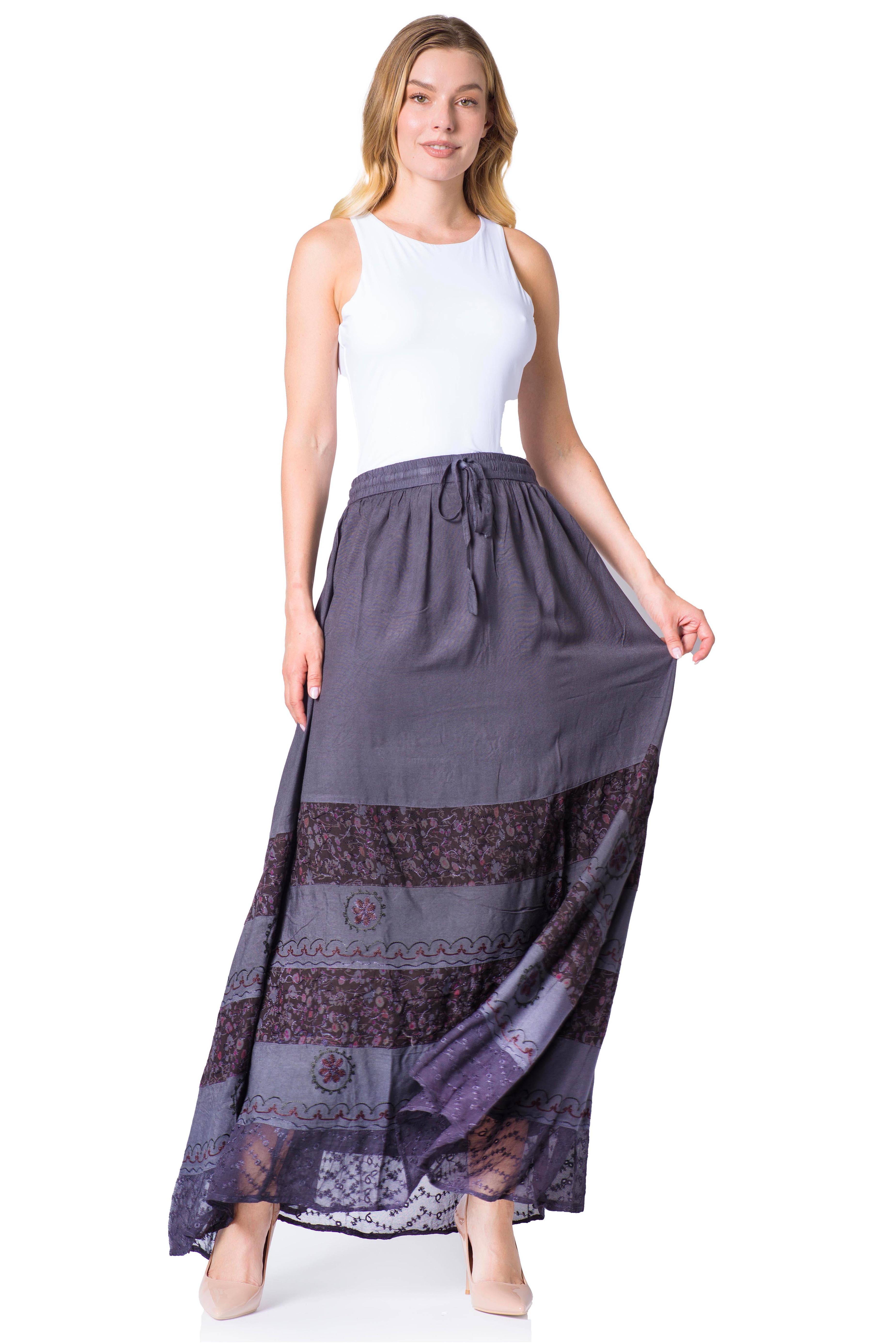 Woman wearing a long, patterned skirt on a white background