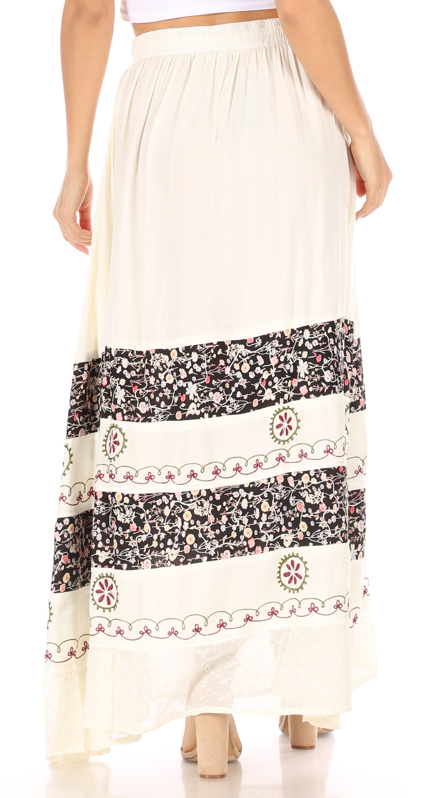 Long white skirt with black and red patterned hem on a white background