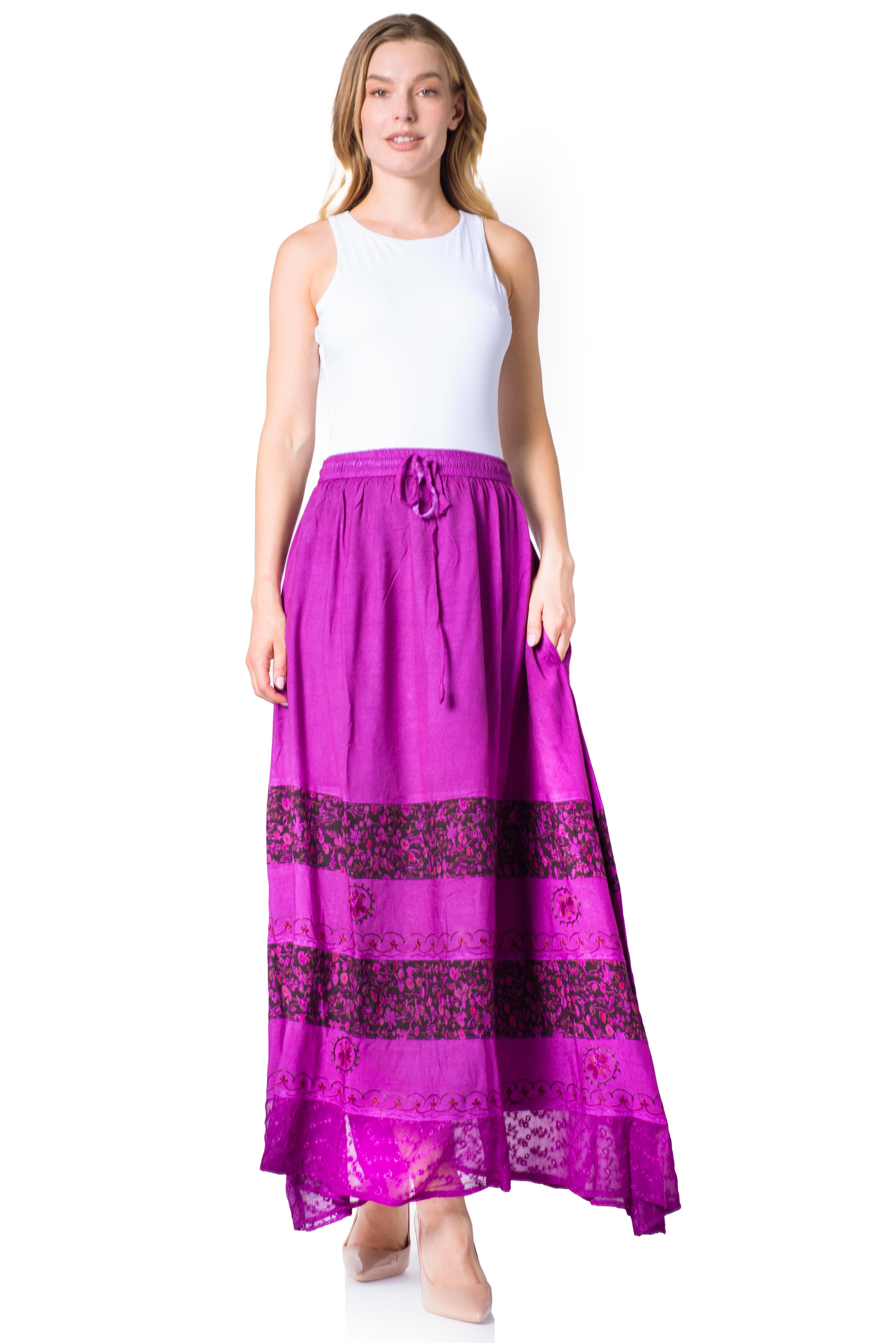 Woman wearing a long purple skirt with lace details on a white background