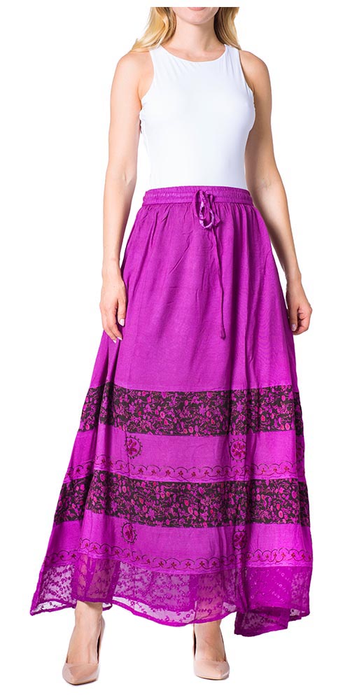 Woman wearing a long purple skirt with floral patterns on a white background
