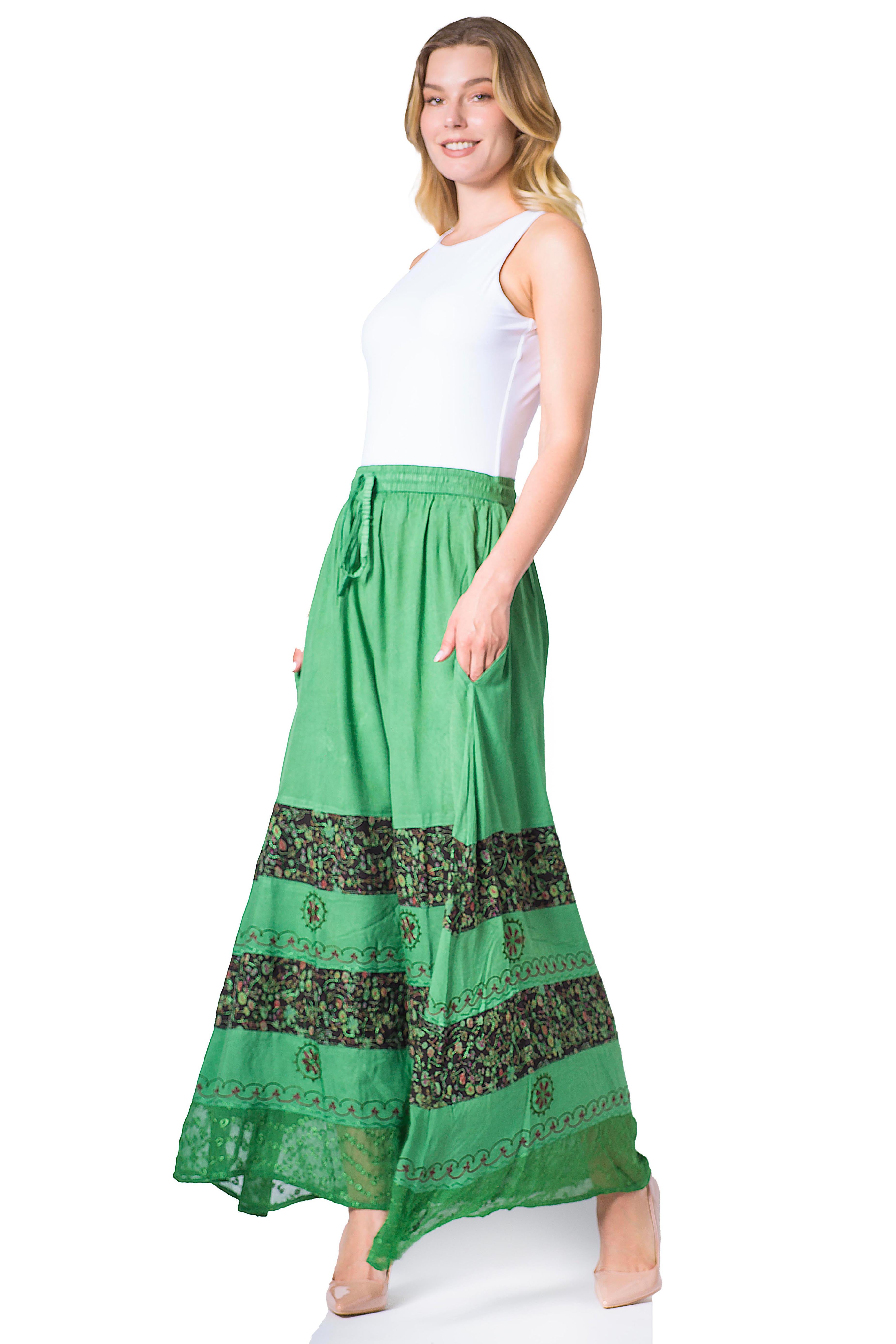 Woman wearing a green skirt with a white top on a white background