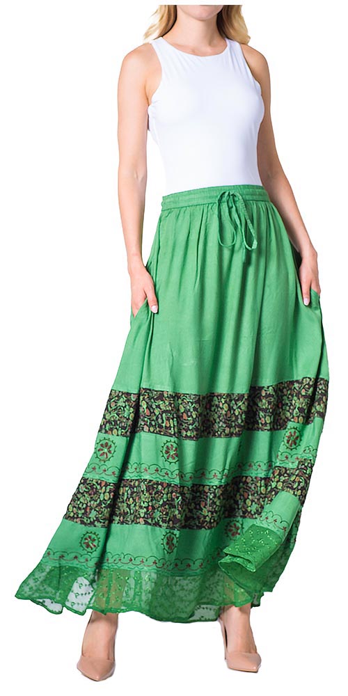 Green long skirt with floral patterns worn by a model on a white background