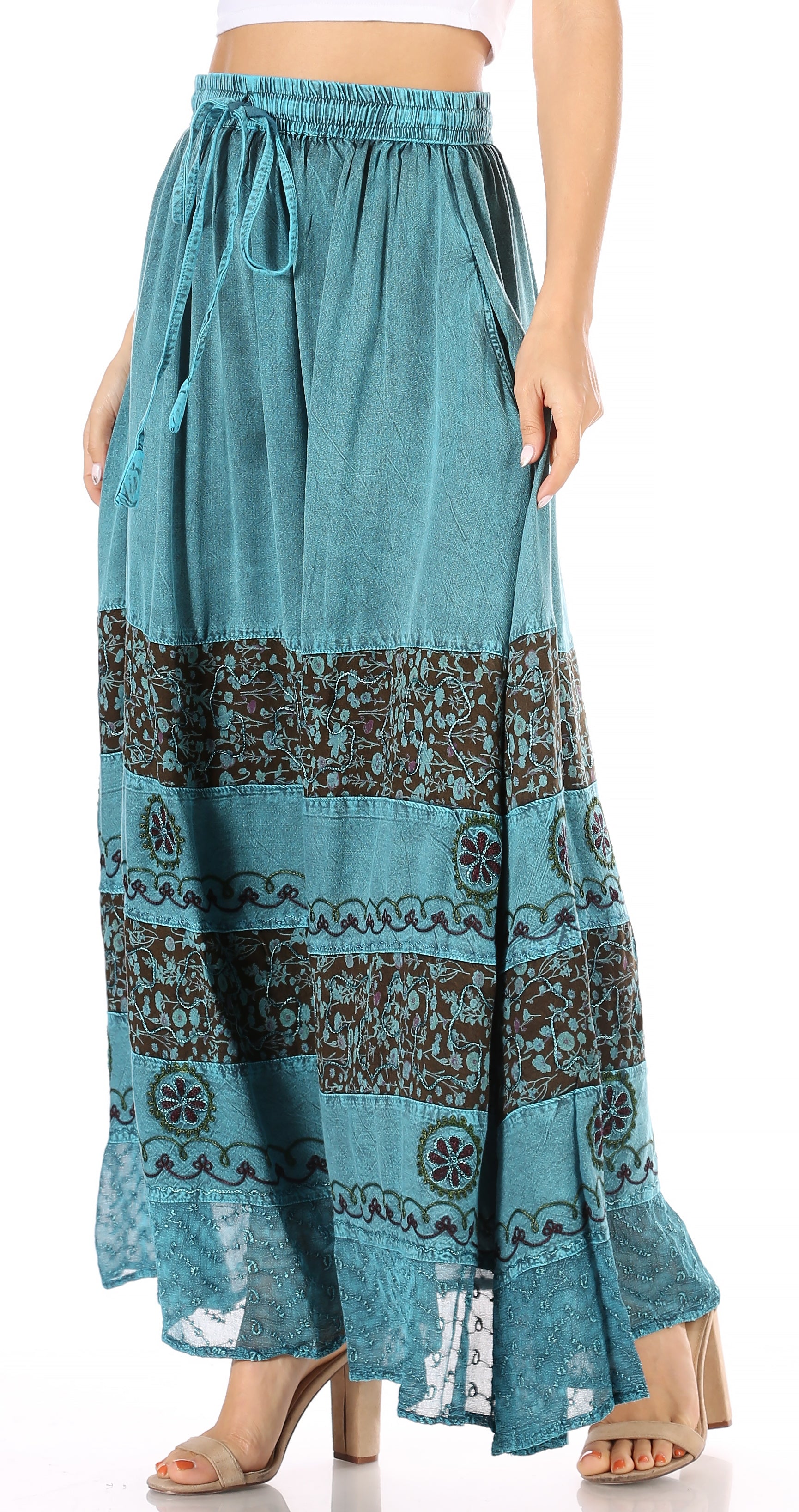 Teal patterned maxi skirt worn by a person on a white background