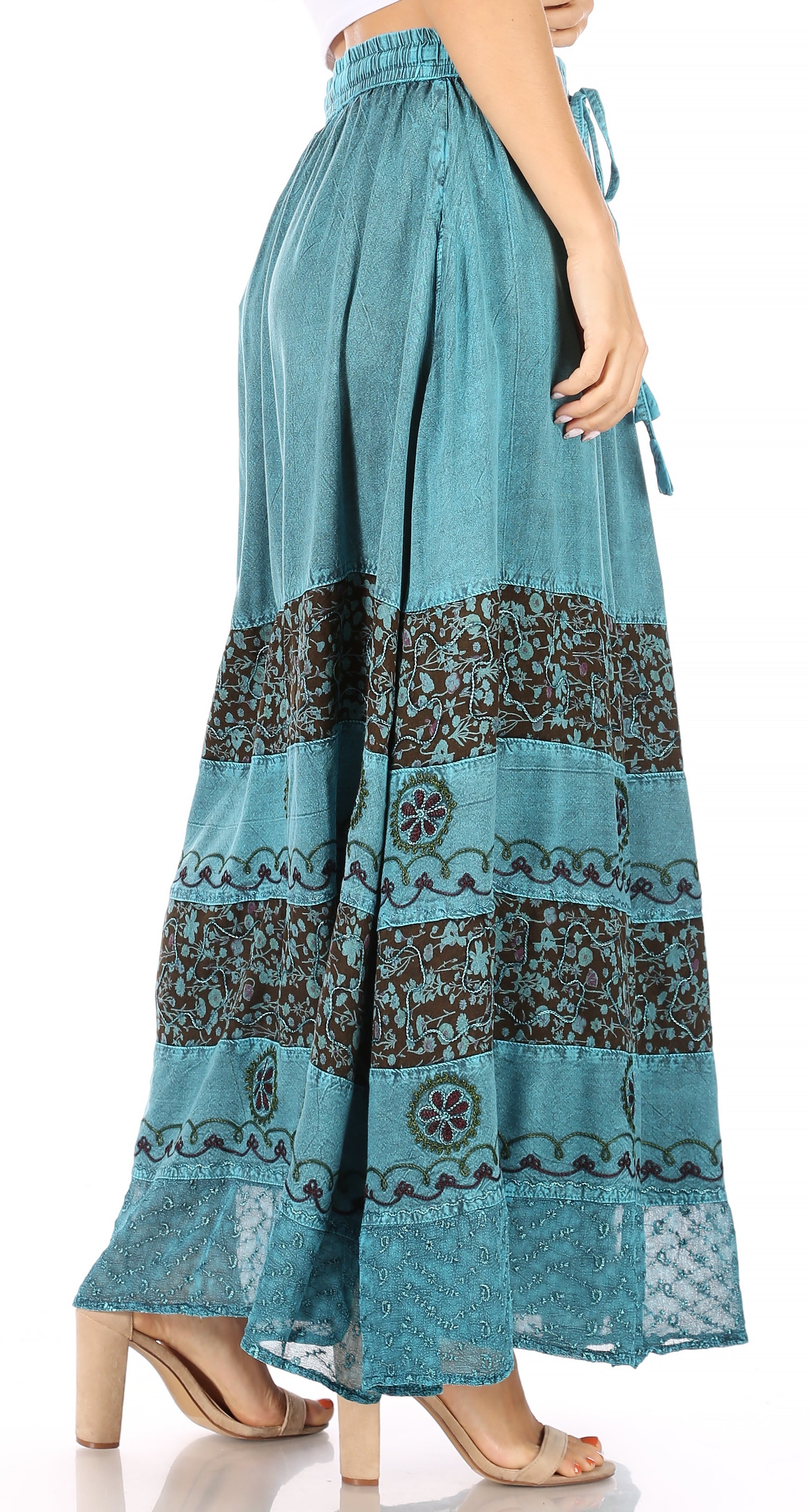 Teal maxi skirt with patterned bottom section on a white background
