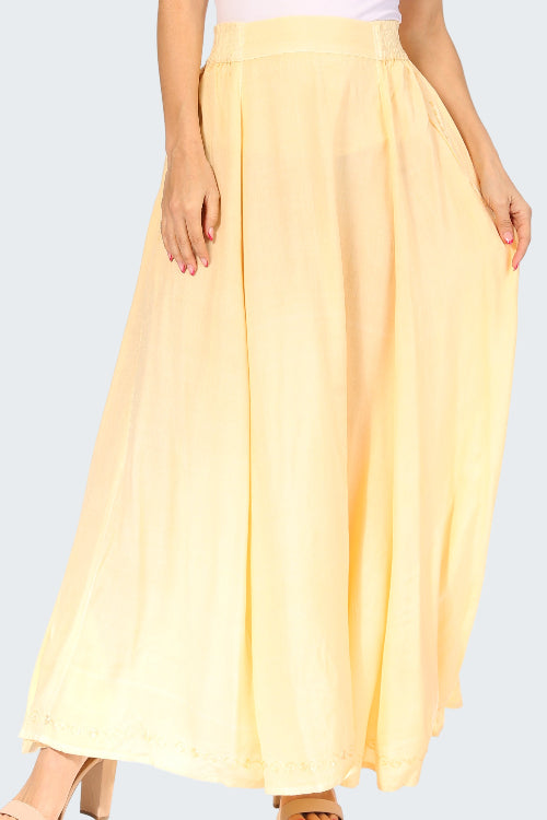 Yellow skirt worn by a person on a white background