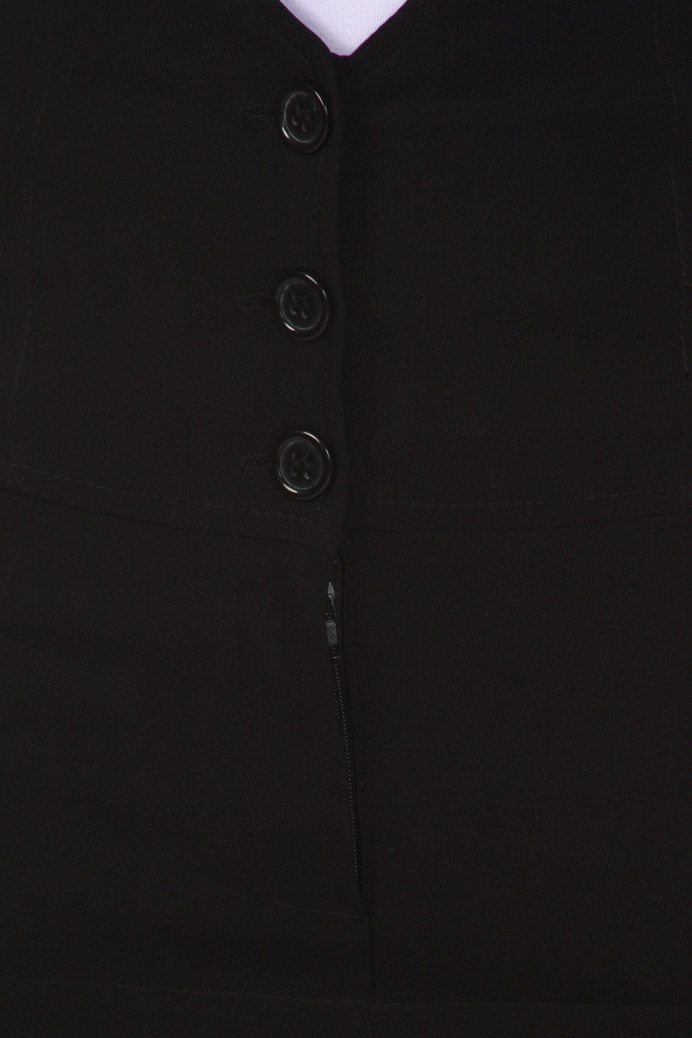 Close-up of a black buttoned garment with a white collar.