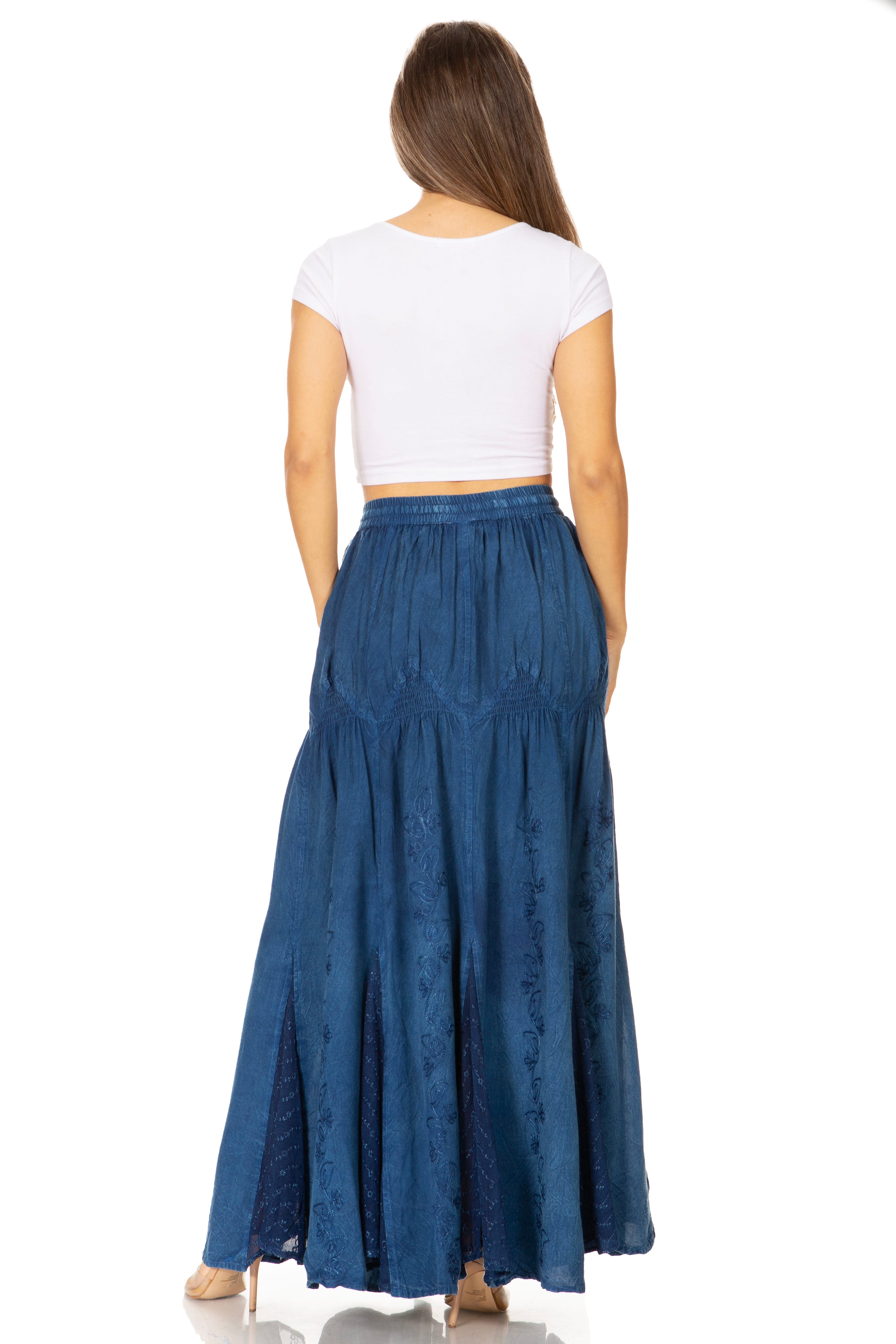 Woman wearing a long blue skirt and white top on a white background