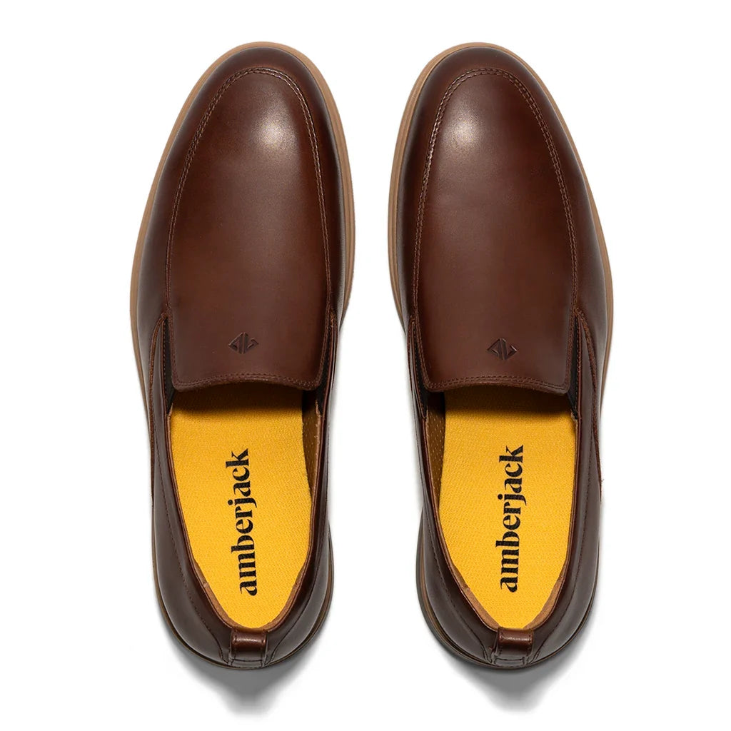 Brown leather shoes with yellow insole displaying 'amberjack' brand on a white background