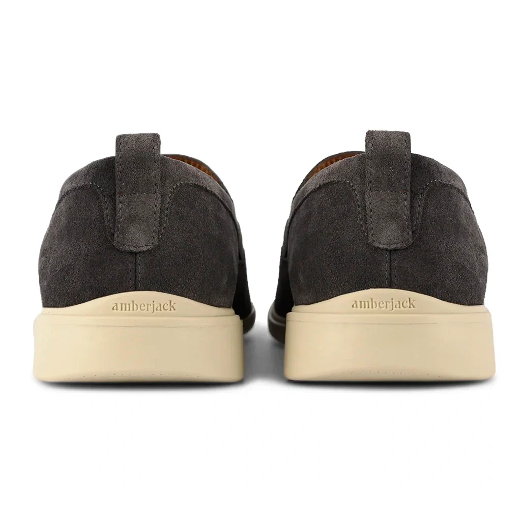 Pair of dark brown suede shoes with beige soles on a white background, featuring the brand 'amberjack'.