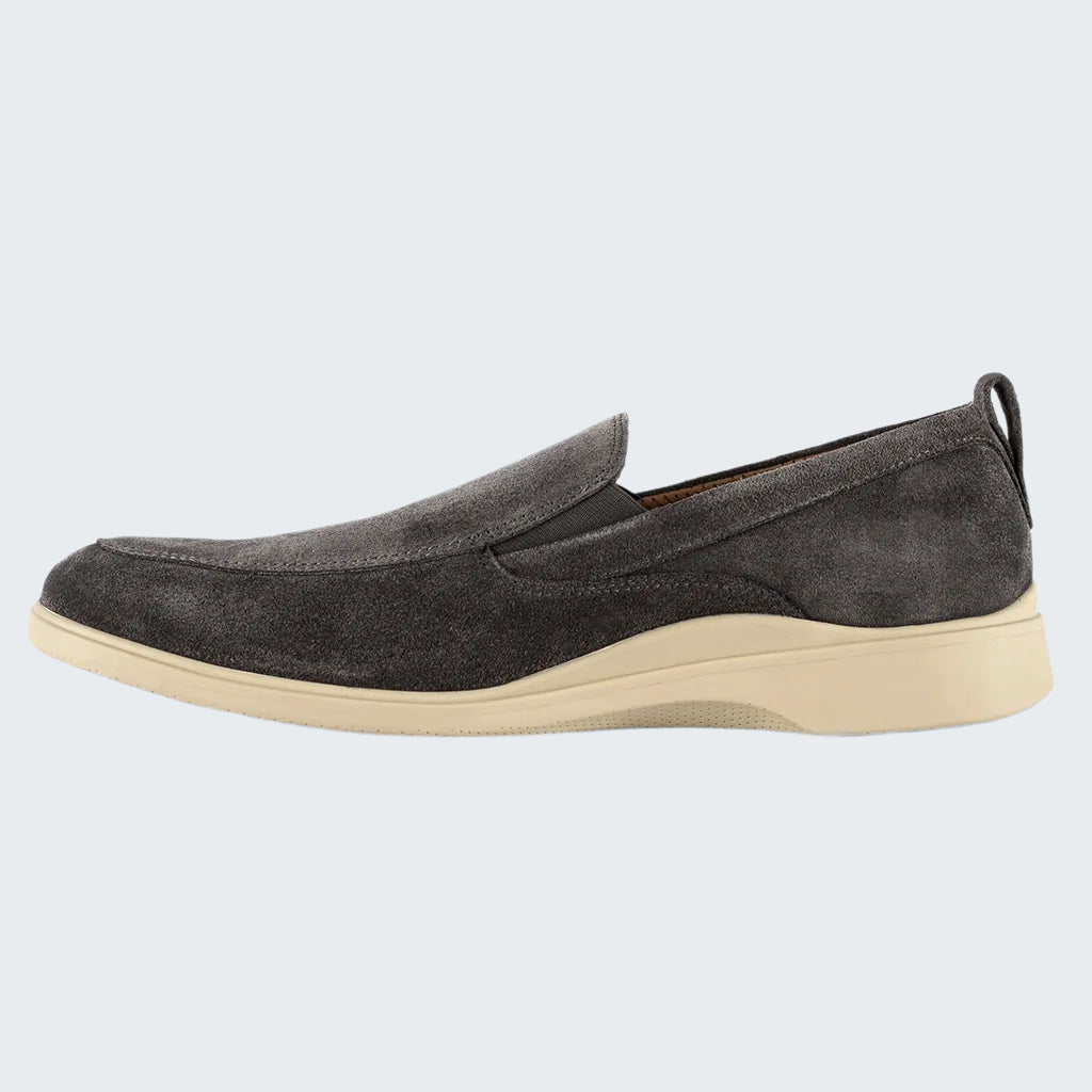 Gray slip-on shoe with a white sole on a white background