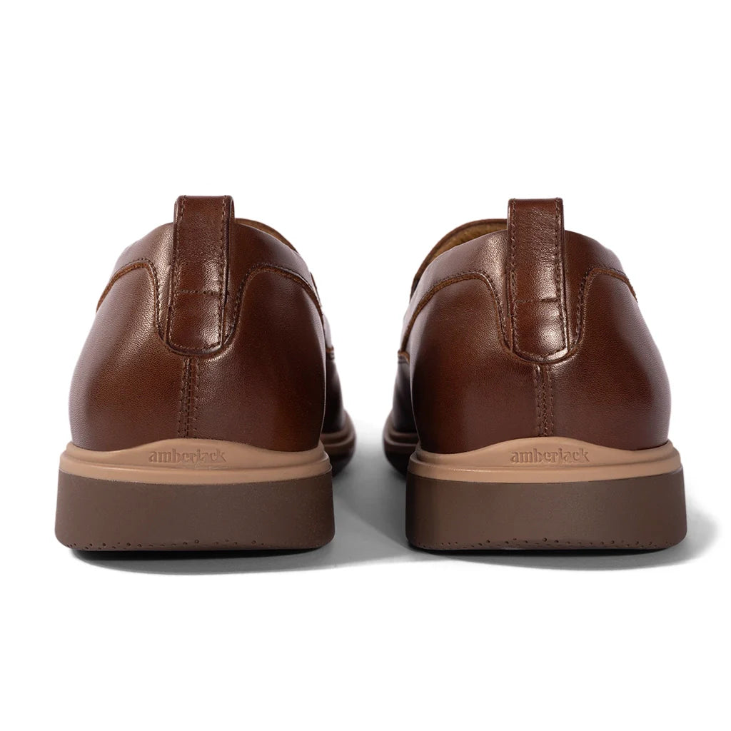 Pair of brown leather shoes with 'amberlock' branding on a white background