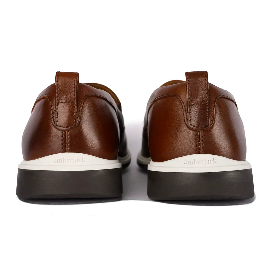 Brown leather shoes with white soles on a white background