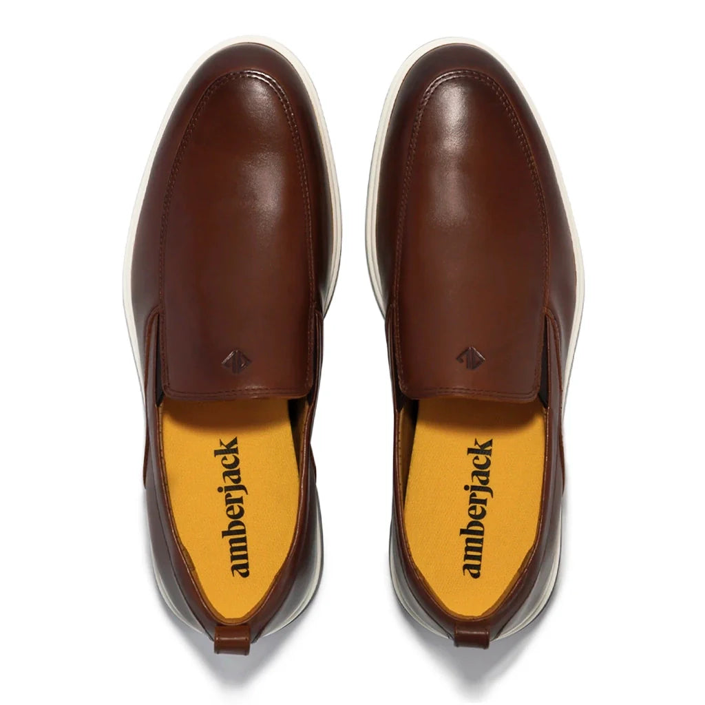 Brown leather shoes with 'amberjack' branding on a white background