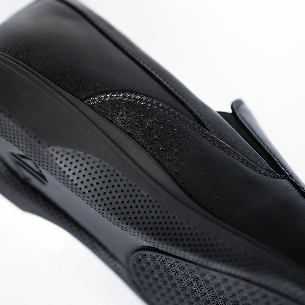 Close-up of a black leather product with textured surface on a white background