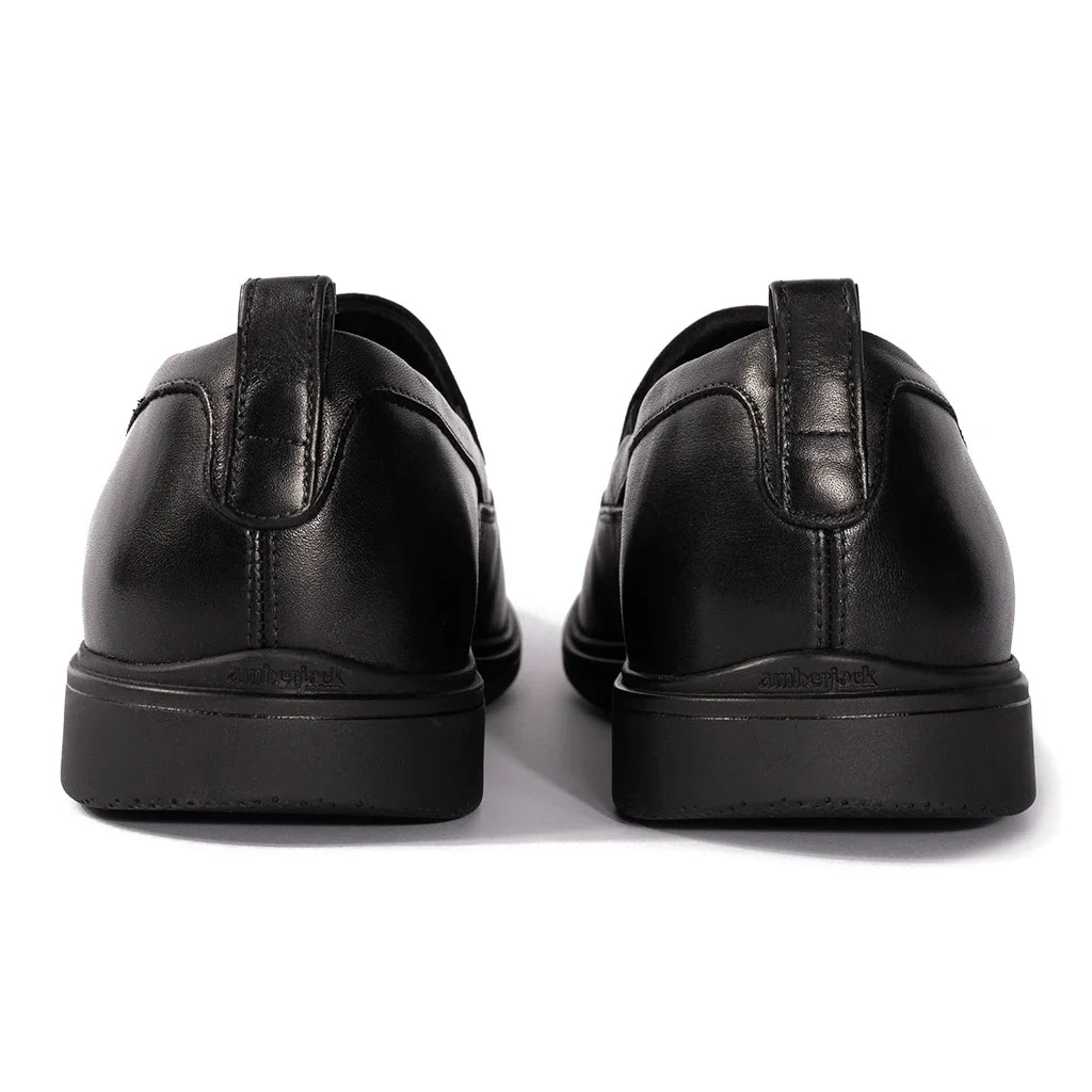 Black leather shoes on a white background