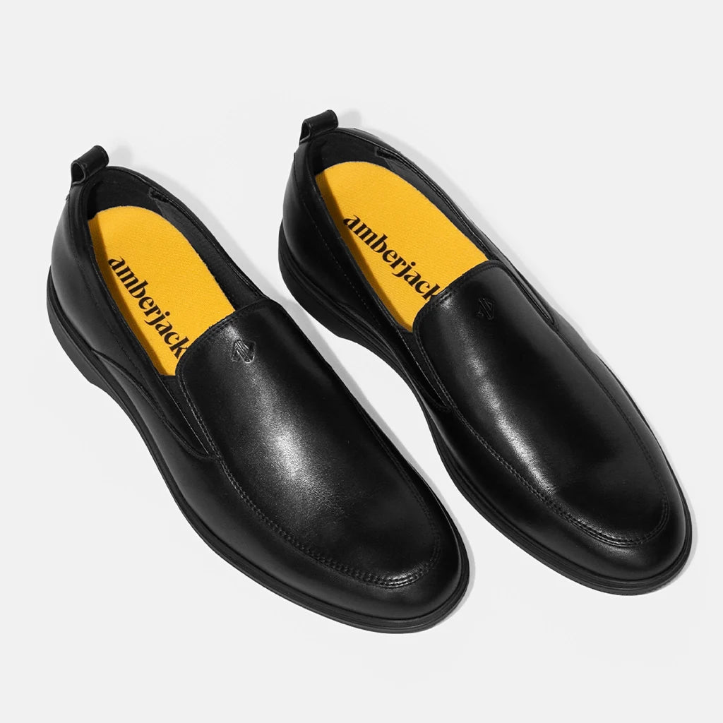 Black shoes with yellow interior and 'amberjack' branding on a white background