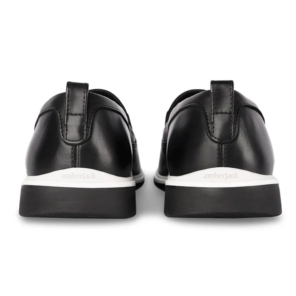 Black sneakers with white soles on a white background